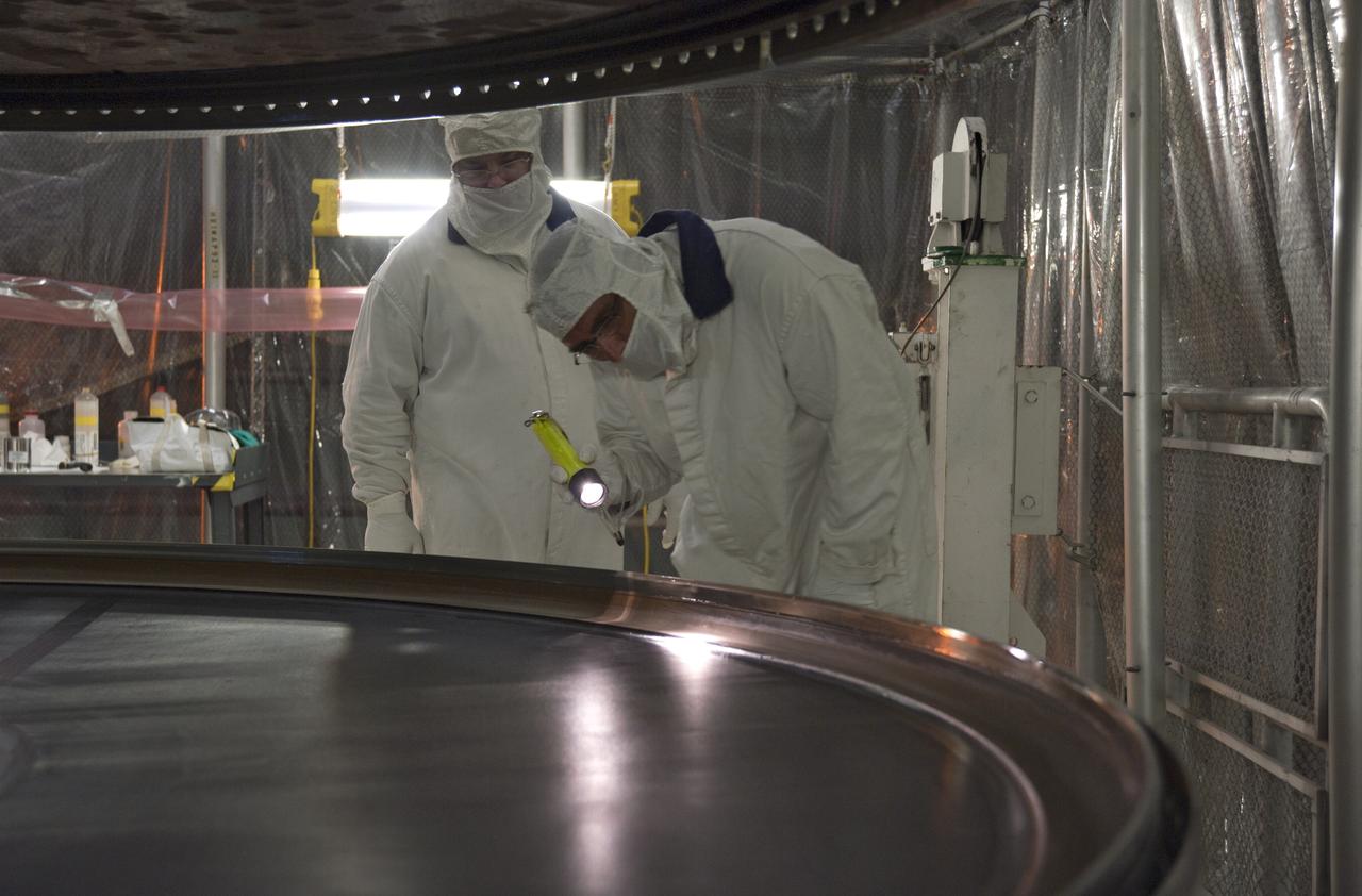 CAPE CANAVERAL, Fla. -- In the Vehicle Assembly Building at NASA's Kennedy Space Center in Florida, technicians check the alignment of the rubber rings after installation to the left forward center solid rocket booster segment.        The booster along with its twin will be stacked on the mobile launcher platform along with an external fuel tank awaiting the arrival of space shuttle Endeavour for its flight to the International Space Station. As the final planned mission of the Space Shuttle Program, Endeavour and its crew will deliver the Alpha Magnetic Spectrometer, as well as critical spare components to the station on the STS-134 mission targeted for launch Feb. 26, 2011. For more information visit, http://www.nasa.gov/mission_pages/shuttle/shuttlemissions/sts134/index.html. Photo credit: NASA/Kim Shiflett