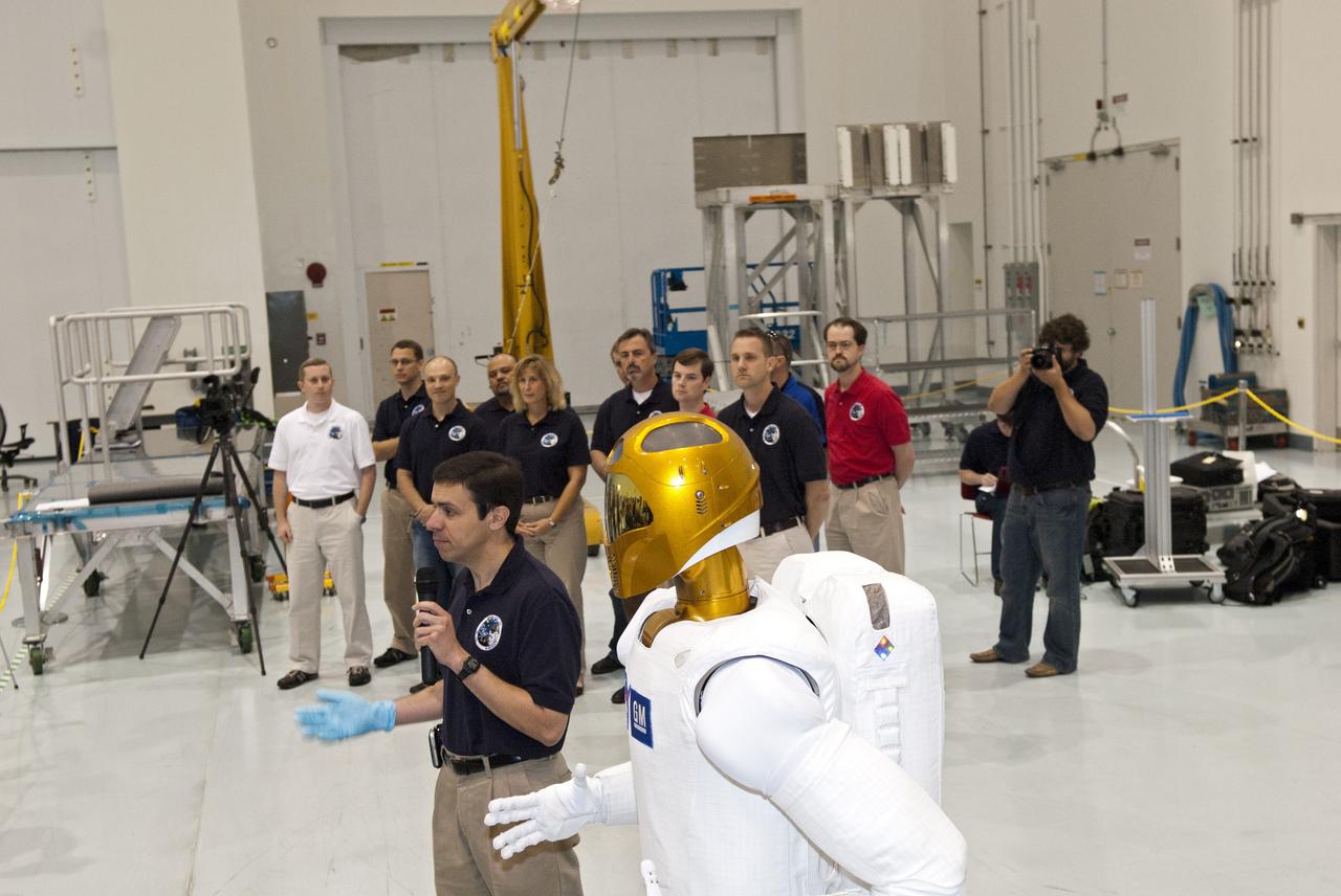 CAPE CANAVERAL, Fla. -- In the Space Station Processing Facility at NASA's Kennedy Space Center in Florida, Ron Diftler, NASA Robonaut project manager, talks to the media about the dexterous humanoid astronaut helper, Robonaut (R2).               R2 will fly to the International Space Station aboard space shuttle Discovery on the STS-133 mission. Although it will initially only participate in operational tests, upgrades could eventually allow the robot to realize its true purpose -- helping spacewalking astronauts with tasks outside the space station. Photo credit: NASA/Jim Grossmann