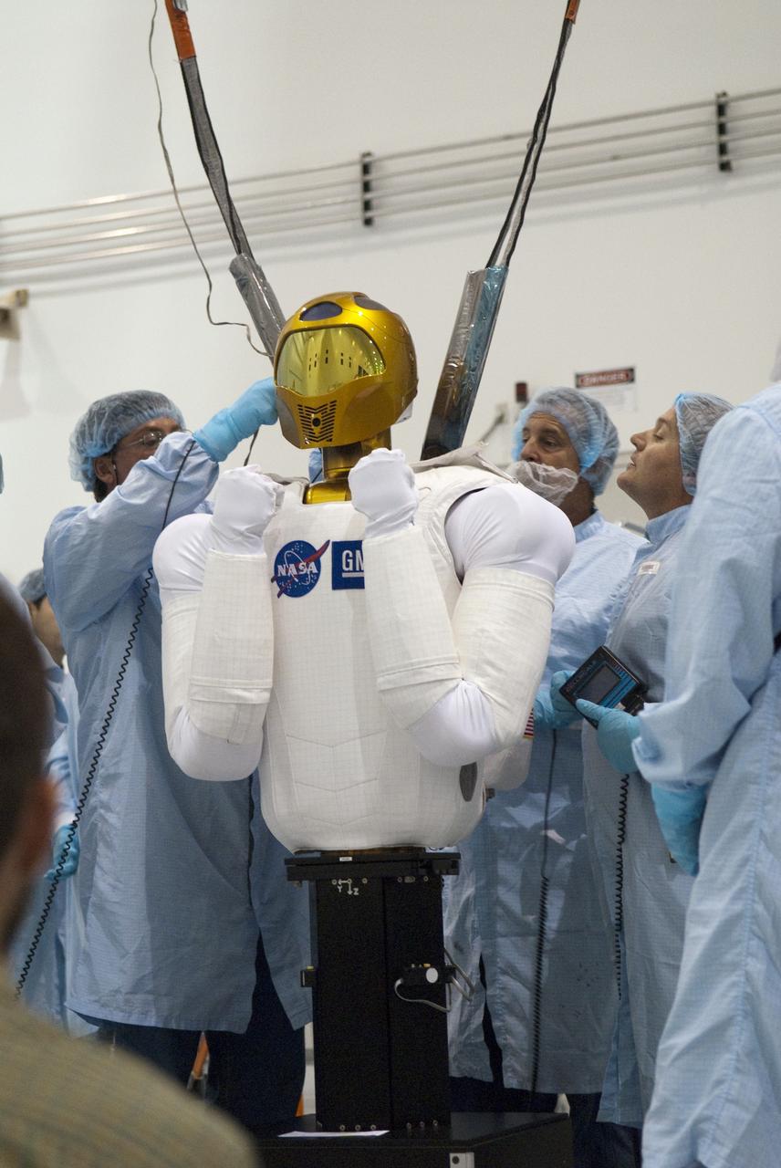 CAPE CANAVERAL, Fla. -- In the Space Station Processing Facility at NASA's Kennedy Space Center in Florida, the dexterous humanoid astronaut helper, Robonaut 2, or R2, is prepared for its lift and installation in a launch box called SLEEPR, or Structural Launch Enclosure to Effectively Protect Robonaut.     R2 will fly to the International Space Station aboard space shuttle Discovery on the STS-133 mission. Although it will initially only participate in operational tests, upgrades could eventually allow the robot to realize its true purpose -- helping spacewalking astronauts with tasks outside the space station. Photo credit: NASA/Frankie Martin