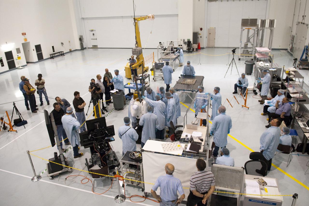 CAPE CANAVERAL, Fla. -- In the Space Station Processing Facility at NASA's Kennedy Space Center in Florida, the dexterous humanoid astronaut helper, Robonaut 2, or R2, is prepared for its lift and installation in a launch box called SLEEPR, or Structural Launch Enclosure to Effectively Protect Robonaut.     R2 will fly to the International Space Station aboard space shuttle Discovery on the STS-133 mission. Although it will initially only participate in operational tests, upgrades could eventually allow the robot to realize its true purpose -- helping spacewalking astronauts with tasks outside the space station. Photo credit: NASA/Frankie Martin