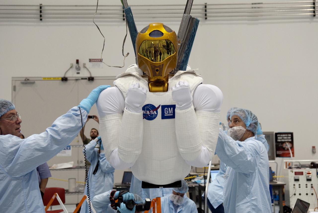 CAPE CANAVERAL, Fla. -- In the Space Station Processing Facility at NASA's Kennedy Space Center in Florida, the dexterous humanoid astronaut helper, Robonaut 2, or R2, is lifted for its installation in a launch box called SLEEPR, or Structural Launch Enclosure to Effectively Protect Robonaut.     R2 will fly to the International Space Station aboard space shuttle Discovery on the STS-133 mission. Although it will initially only participate in operational tests, upgrades could eventually allow the robot to realize its true purpose -- helping spacewalking astronauts with tasks outside the space station. Photo credit: NASA/Frankie Martin