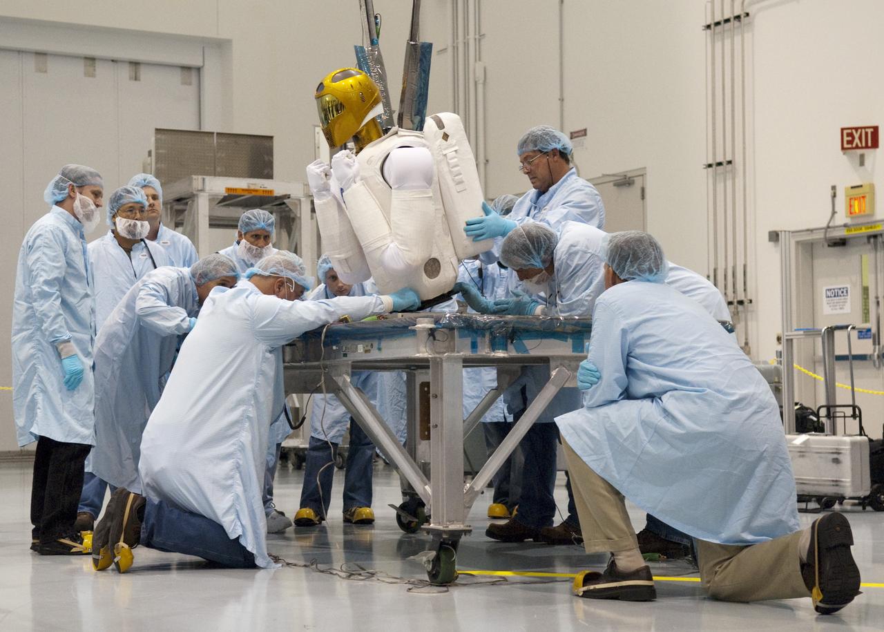 CAPE CANAVERAL, Fla. -- In the Space Station Processing Facility at NASA's Kennedy Space Center in Florida, the dexterous humanoid astronaut helper, Robonaut 2, or R2, is secured to a base plate, which is part of its launch box called SLEEPR, or Structural Launch Enclosure to Effectively Protect Robonaut.    R2 will fly to the International Space Station aboard space shuttle Discovery on the STS-133 mission. Although it will initially only participate in operational tests, upgrades could eventually allow the robot to realize its true purpose -- helping spacewalking astronauts with tasks outside the space station. Photo credit: NASA/Frankie Martin