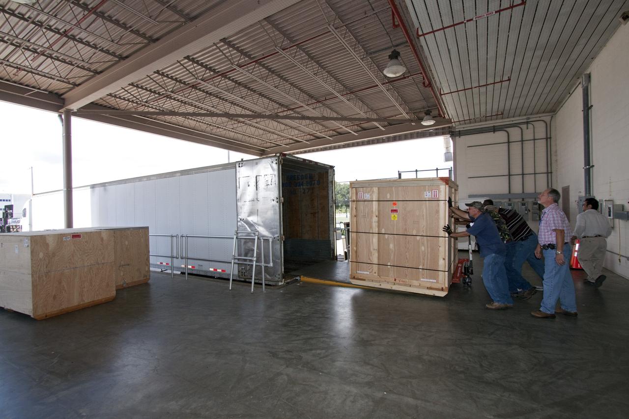 CAPE CANAVERAL, Fla. -- In the Space Station Processing Facility at NASA's Kennedy Space Center in Florida, shipping containers packed with tools and flight support equipment for orbital replacement units are loaded into a tractor-trailer for their trip to the Japanese Aerospace Exploration Agency's Tanegashima Space Center. There, the six units, including the flex hose rotary coupler, will be processed for launch to the International Space Station aboard HTV-2, scheduled for Jan. 20, 2011.     HTV-2 is an uncrewed cargo transporter that will be launched by the H-IIB launch vehicle. It is designed to deliver up to 6 tons of supplies, including food, clothes and experiment devices to the space station. Photo credit: NASA/Jack Pfaller