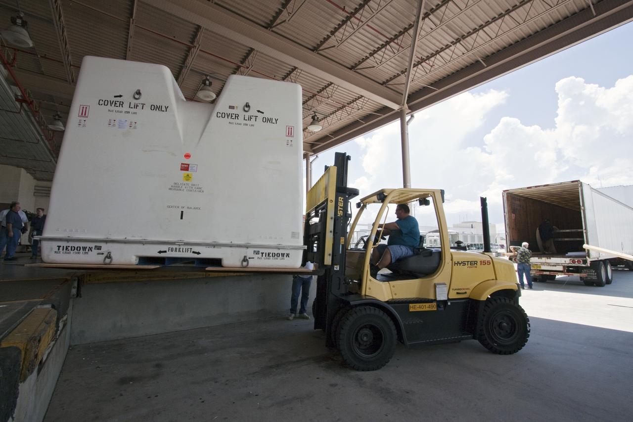 CAPE CANAVERAL, Fla. -- In the Space Station Processing Facility at NASA's Kennedy Space Center in Florida, a forklift moves shipping containers packed with tools and flight support equipment for orbital replacement units into a tractor-trailer for their trip to the Japanese Aerospace Exploration Agency's Tanegashima Space Center. There, the six units, including the flex hose rotary coupler, will be processed for launch to the International Space Station aboard HTV-2, scheduled for Jan. 20, 2011.    HTV-2 is an uncrewed cargo transporter that will be launched by the H-IIB launch vehicle. It is designed to deliver up to 6 tons of supplies, including food, clothes and experiment devices to the space station. Photo credit: NASA/Jack Pfaller