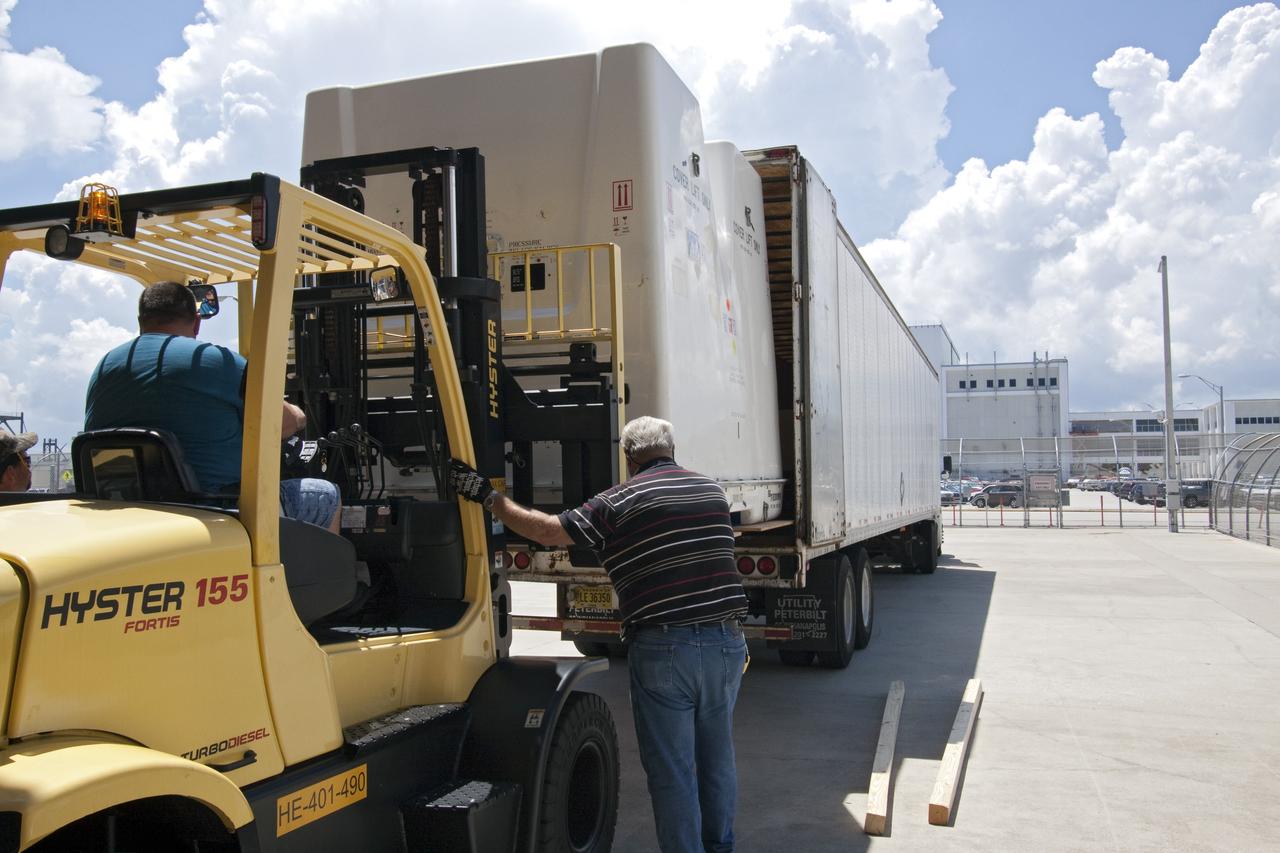 CAPE CANAVERAL, Fla. -- In the Space Station Processing Facility at NASA's Kennedy Space Center in Florida, a forklift moves shipping containers packed with tools and flight support equipment for orbital replacement units into a tractor-trailer for their trip to the Japanese Aerospace Exploration Agency's Tanegashima Space Center. There, the six units, including the flex hose rotary coupler, will be processed for launch to the International Space Station aboard HTV-2, scheduled for Jan. 20, 2011.    HTV-2 is an uncrewed cargo transporter that will be launched by the H-IIB launch vehicle. It is designed to deliver up to 6 tons of supplies, including food, clothes and experiment devices to the space station. Photo credit: NASA/Jack Pfaller