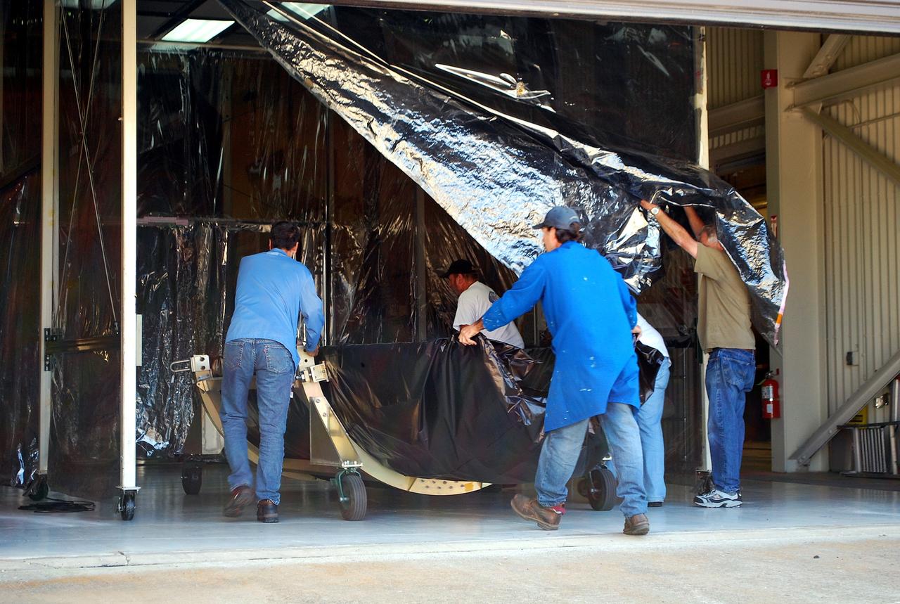 VANDENBERG AIR FORCE BASE, Calif. -- At Vandenberg Air Force Base in California, one half of the fairing that will envelop NASA's Glory satellite is moved into a protected environment of VAFB's payload processing facility. Both halves of the fairing will be installed around the spacecraft to protect it from the weather on the ground as well as from the atmosphere during flight.            A four-stage Taurus XL rocket will carry Glory into low Earth orbit. Once Glory reaches orbit, it will collect data on the properties of aerosols and black carbon. It also will help scientists understand how the sun's irradiance affects Earth's climate. Launch is scheduled for 2:09 a.m. PST Nov. 22. For information, visit www.nasa.gov/glory. Photo credit: NASA/Randy Beaudoin, VAFB