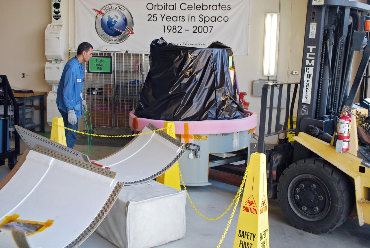 VANDENBERG AIR FORCE BASE, Calif. -- At Vandenberg Air Force Base in California, the payload cone is lowered onto the floor of VAFB's payload processing facility for NASA's Glory mission. The payload cone is an adapter that interfaces the Taurus XL rocket with the spacecraft. A four-stage Taurus XL rocket will carry Glory into low Earth orbit. Once Glory reaches orbit, it will collect data on the properties of aerosols and black carbon. It also will help scientists understand how the sun's irradiance affects Earth's climate. Launch is scheduled for 2:09 a.m. PST Nov. 22. For information, visit www.nasa.gov/glory. Photo credit: NASA/Randy Beaudoin, VAFB