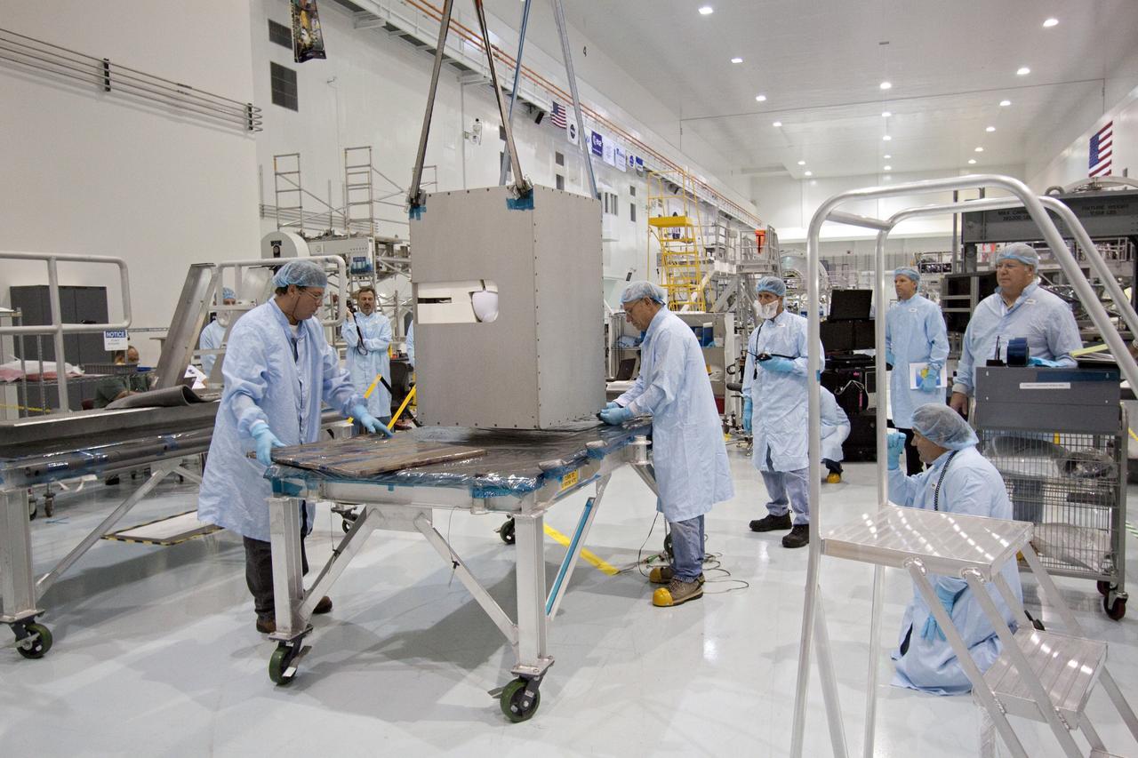 CAPE CANAVERAL, Fla. -- The dexterous humanoid astronaut helper, Robonaut 2, or R2, begins is move to a horizontal position in the Space Station Processing Facility at NASA's Kennedy Space Center in Florida. Packed inside a launch box called SLEEPR, or Structural Launch Enclosure to Effectively Protect Robonaut, R2 will be placed in the Permanent Multipurpose Module, or PMM, in the same launch orientation as space shuttle Discovery's STS-133 crew members -- facing toward the nose of the shuttle with the back taking all the weight.     Although R2 will initially only participate in operational tests, upgrades could eventually allow the robot to realize its true purpose -- helping spacewalking astronauts with tasks outside the International Space Station. STS-133 is targeted to launch Nov. 1.  Photo credit: NASA/Jack Pfaller