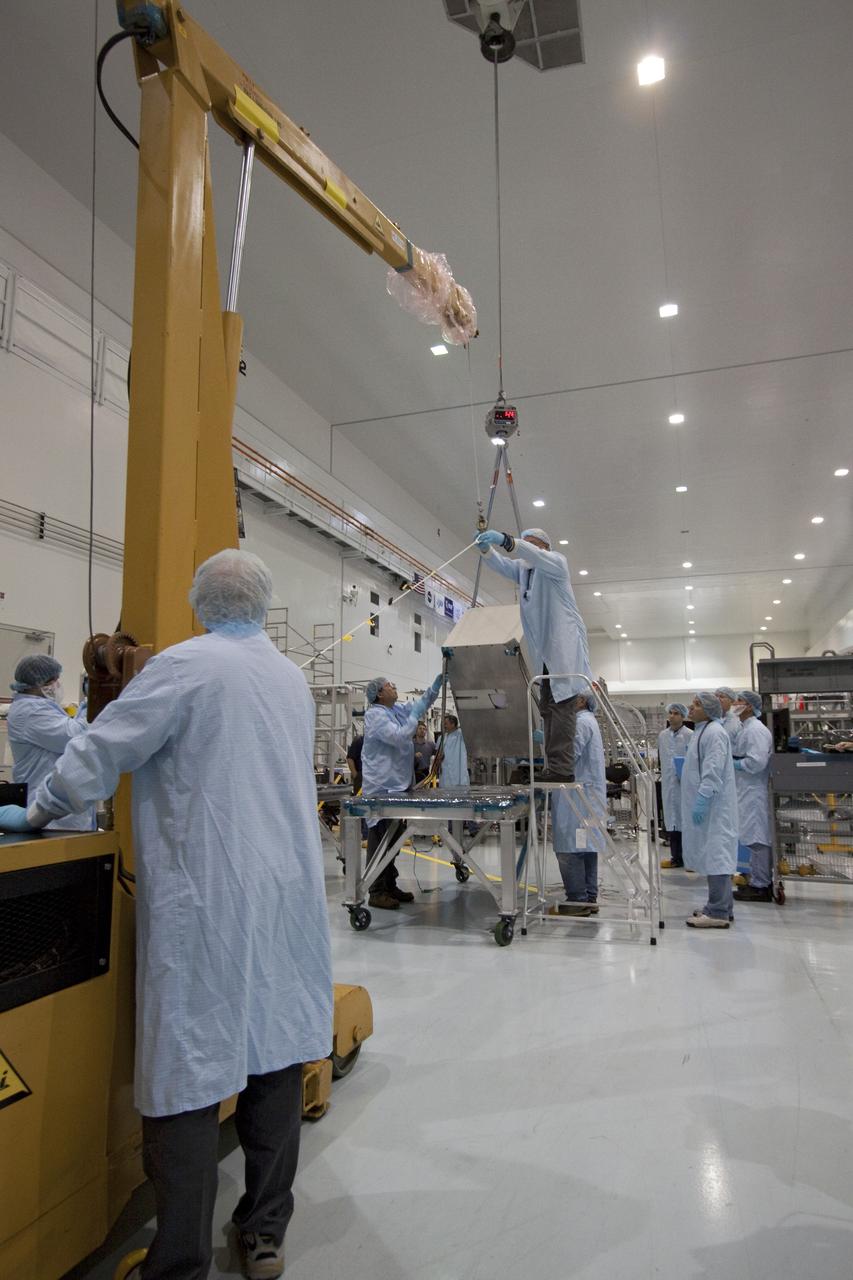 CAPE CANAVERAL, Fla. -- The dexterous humanoid astronaut helper, Robonaut 2, or R2, is moved to a horizontal position in the Space Station Processing Facility at NASA's Kennedy Space Center in Florida. Packed inside a launch box called SLEEPR, or Structural Launch Enclosure to Effectively Protect Robonaut, R2 will be placed in the Permanent Multipurpose Module, or PMM, in the same launch orientation as space shuttle Discovery's STS-133 crew members -- facing toward the nose of the shuttle with the back taking all the weight.     Although R2 will initially only participate in operational tests, upgrades could eventually allow the robot to realize its true purpose -- helping spacewalking astronauts with tasks outside the International Space Station. STS-133 is targeted to launch Nov. 1.  Photo credit: NASA/Jack Pfaller