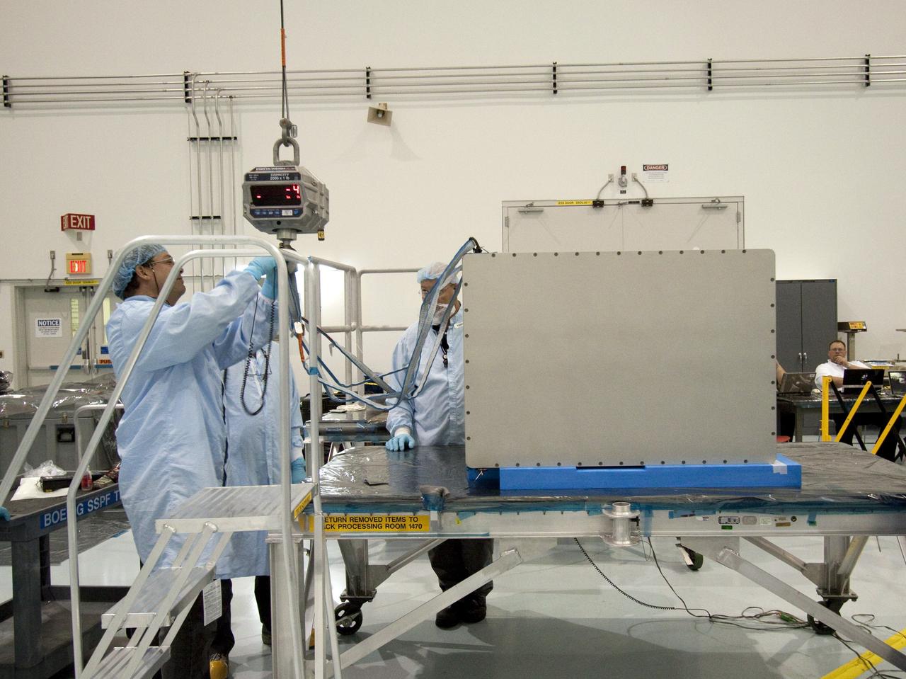 CAPE CANAVERAL, Fla. -- The dexterous humanoid astronaut helper, Robonaut 2, or R2, is moved to a horizontal position in the Space Station Processing Facility at NASA's Kennedy Space Center in Florida. Packed inside a launch box called SLEEPR, or Structural Launch Enclosure to Effectively Protect Robonaut, R2 will be placed in the Permanent Multipurpose Module, or PMM, in the same launch orientation as space shuttle Discovery's STS-133 crew members -- facing toward the nose of the shuttle with the back taking all the weight.          Although R2 will initially only participate in operational tests, upgrades could eventually allow the robot to realize its true purpose -- helping spacewalking astronauts with tasks outside the International Space Station. STS-133 is targeted to launch Nov. 1.  Photo credit: NASA/Jack Pfaller