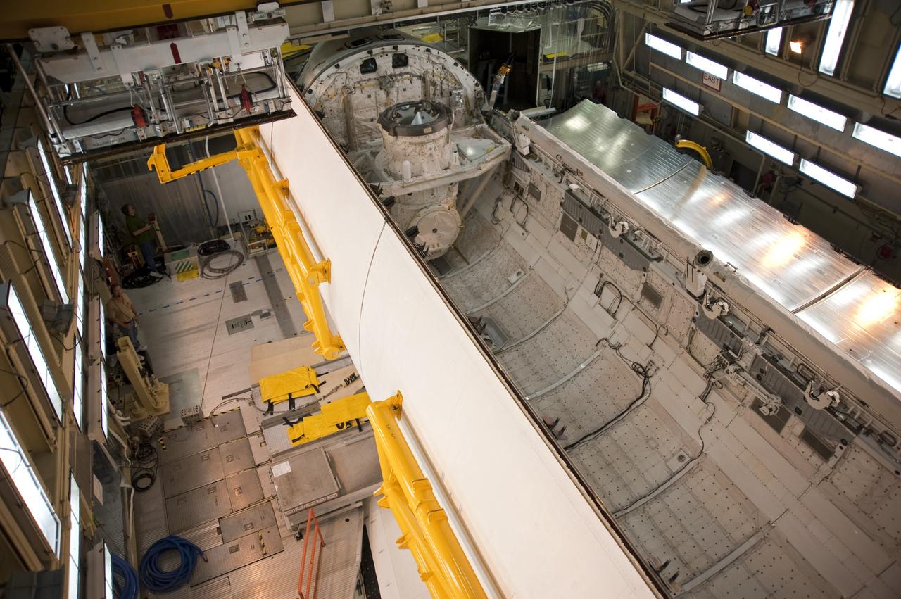 CAPE CANAVERAL, Fla. -- In Orbiter Processing Facility-3 at NASA's Kennedy Space Center in Florida, the clamshell doors of space shuttle Discovery's payload bay begin to close in preparation for the its move  to the Vehicle Assembly Building next month. There, it will be attached to its external fuel tank and a set of solid rocket boosters for launch on the STS-133 mission to the International Space Station.    Targeted to launch Nov. 1, STS-133 will carry the multipurpose logistics module, or PMM, packed with supplies and critical spare parts, as well as Robonaut 2, or R2, to the station. Discovery will leave the module behind so it can be used for microgravity experiments in fluid physics, materials science, biology and biotechnology. Photo credit: NASA/Kim Shiflett
