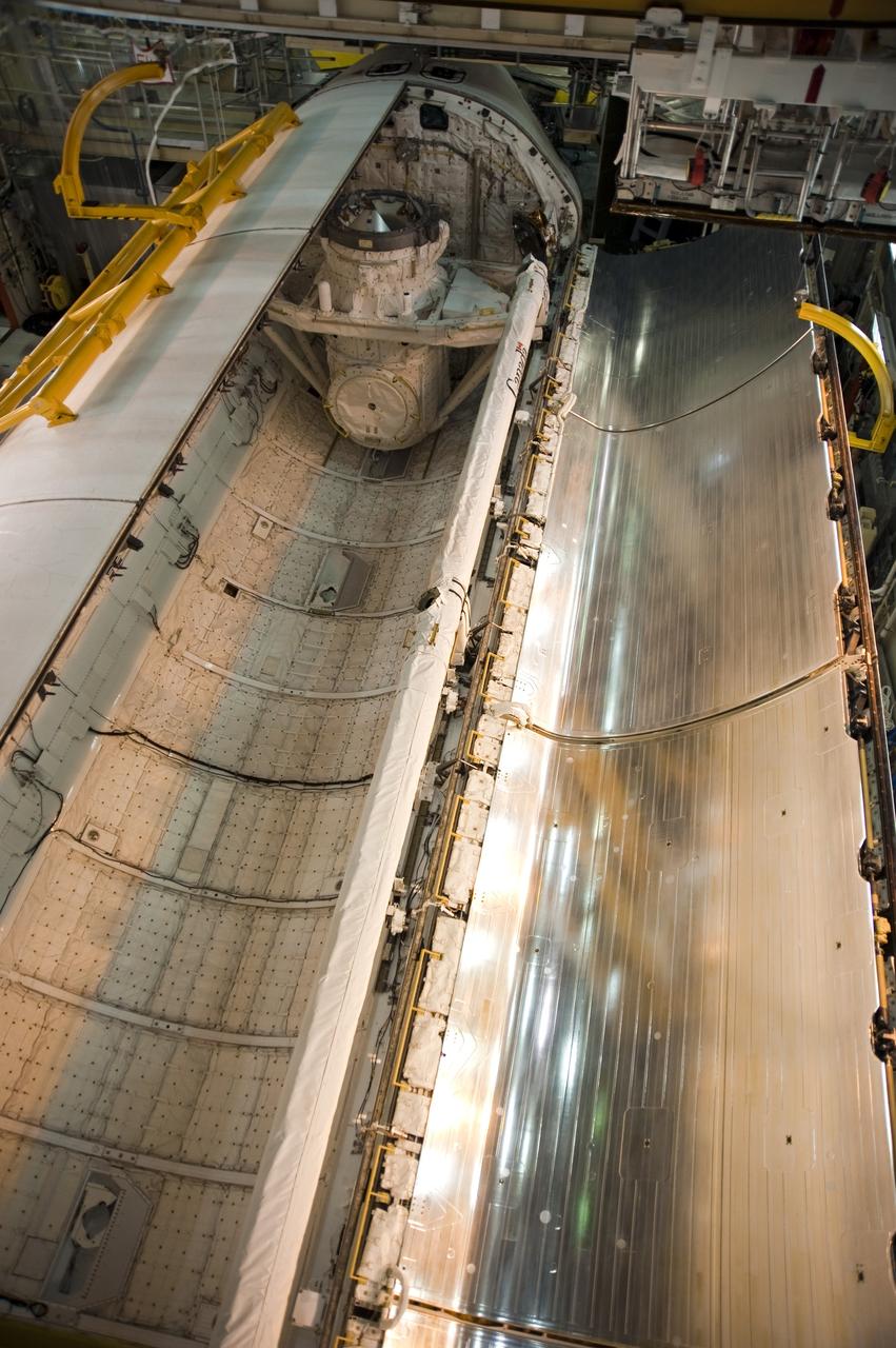 CAPE CANAVERAL, Fla. -- In Orbiter Processing Facility-3 at NASA's Kennedy Space Center in Florida, the clamshell doors of space shuttle Discovery's payload bay close completely in preparation for the its move to the Vehicle Assembly Building next month. There, it will be attached to its external fuel tank and a set of solid rocket boosters for launch on the STS-133 mission to the International Space Station.    Targeted to launch Nov. 1, STS-133 will carry the multipurpose logistics module, or PMM, packed with supplies and critical spare parts, as well as Robonaut 2, or R2, to the station. Discovery will leave the module behind so it can be used for microgravity experiments in fluid physics, materials science, biology and biotechnology. Photo credit: NASA/Kim Shiflett