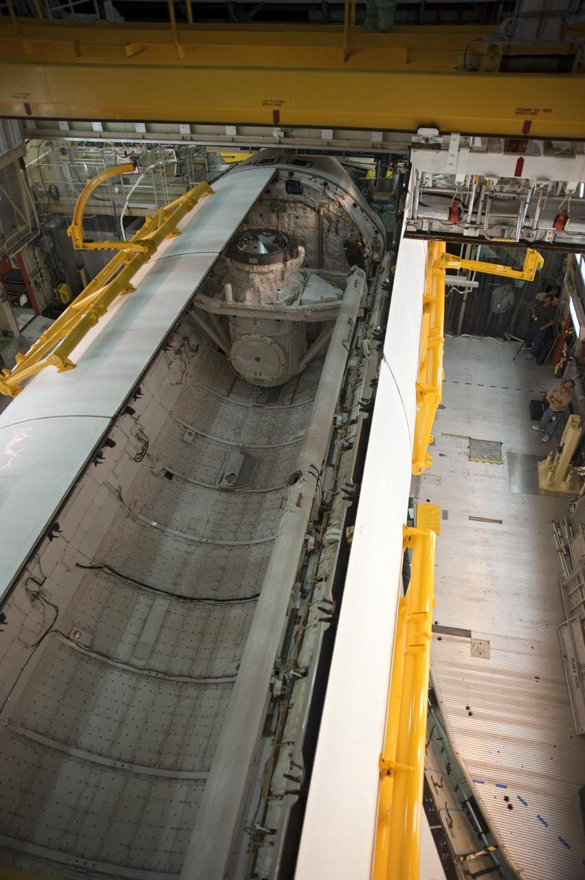 CAPE CANAVERAL, Fla. -- In Orbiter Processing Facility-3 at NASA's Kennedy Space Center in Florida, the clamshell doors of space shuttle Discovery's payload bay close completely in preparation for the its move to the Vehicle Assembly Building next month. There, it will be attached to its external fuel tank and a set of solid rocket boosters for launch on the STS-133 mission to the International Space Station.    Targeted to launch Nov. 1, STS-133 will carry the multipurpose logistics module, or PMM, packed with supplies and critical spare parts, as well as Robonaut 2, or R2, to the station. Discovery will leave the module behind so it can be used for microgravity experiments in fluid physics, materials science, biology and biotechnology. Photo credit: NASA/Kim Shiflett