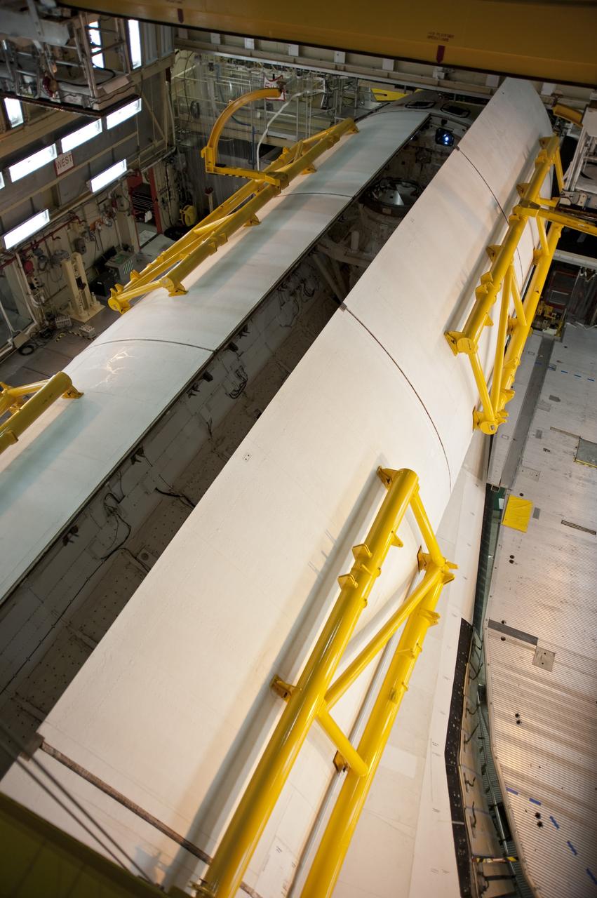 CAPE CANAVERAL, Fla. -- In Orbiter Processing Facility-3 at NASA's Kennedy Space Center in Florida, the clamshell doors of space shuttle Discovery's payload bay close completely in preparation for the its move to the Vehicle Assembly Building next month. There, it will be attached to its external fuel tank and a set of solid rocket boosters for launch on the STS-133 mission to the International Space Station.    Targeted to launch Nov. 1, STS-133 will carry the multipurpose logistics module, or PMM, packed with supplies and critical spare parts, as well as Robonaut 2, or R2, to the station. Discovery will leave the module behind so it can be used for microgravity experiments in fluid physics, materials science, biology and biotechnology. Photo credit: NASA/Kim Shiflett