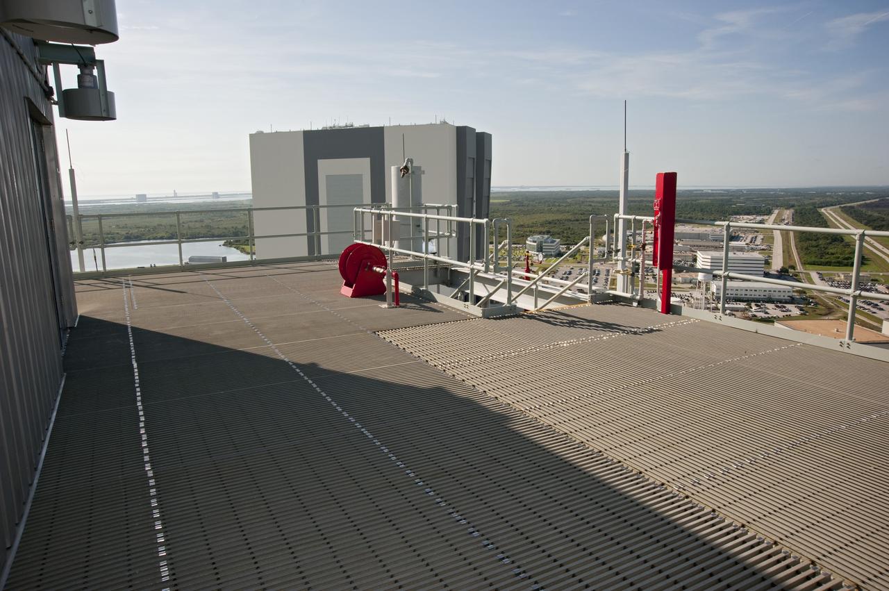 CAPE CANAVERAL, Fla. -- At NASA's Kennedy Space Center in Florida, the top of the 525-foot-tall Vehicle Assembly Building, or VAB, is seen from the tower of NASA's new mobile launcher, or ML, support structure. It took about two years to construct the launcher in the Mobile Launcher Park site, north of the VAB. The 355-foot-tall structure will support NASA's future human spaceflight program. The base of the launcher is lighter than space shuttle mobile launcher platforms so the crawler-transporter can pick up the heavier load of the tower and a taller rocket. The next step will be to add ground support equipment, such as umbilicals and access arms, for future rocket launches. For information on NASA's future plans, visit www.nasa.gov. Photo credit: NASA/Kim Shiflett