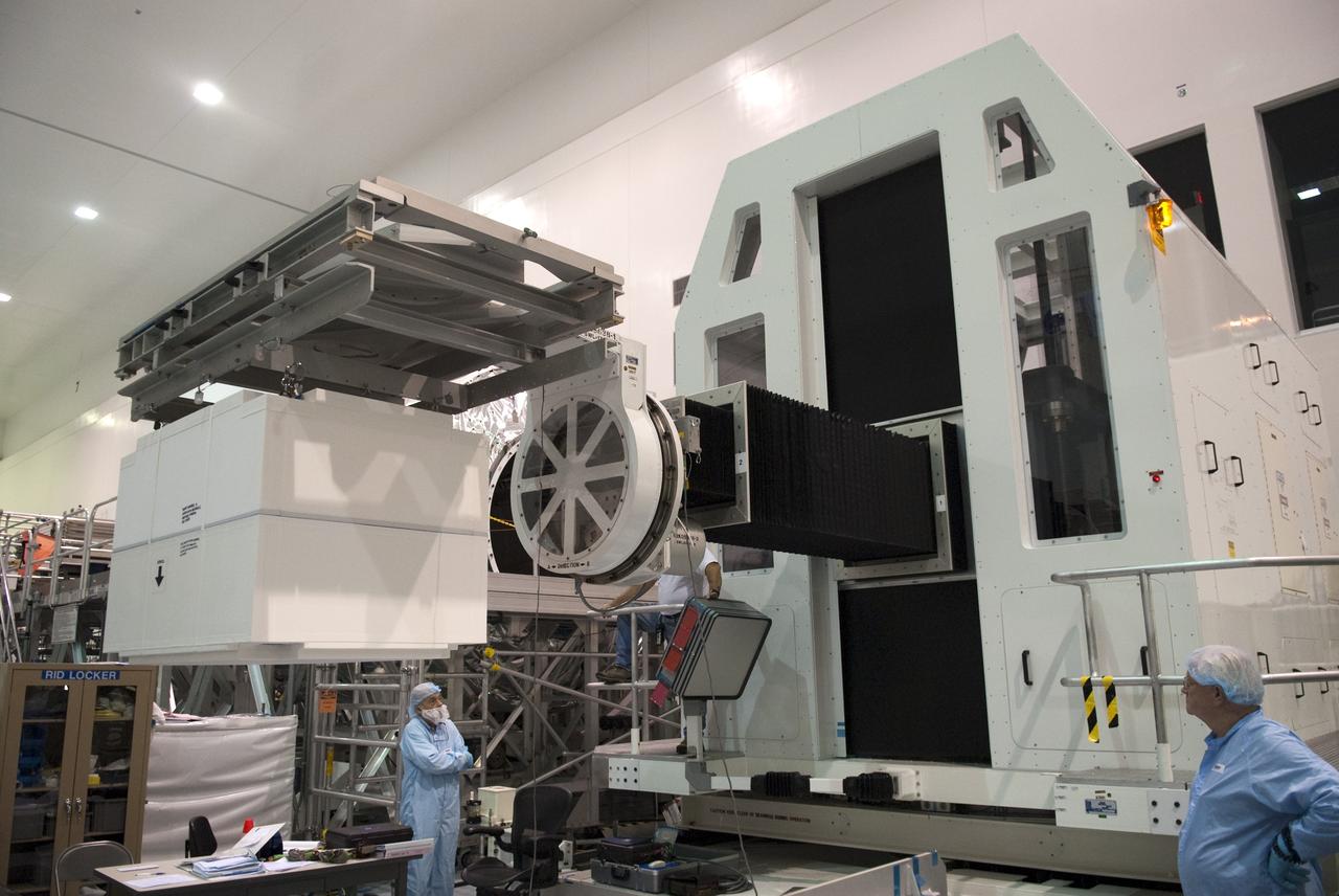 CAPE CANAVERAL, Fla. -- Technicians in the Space Station Processing Facility at NASA's Kennedy Space Center in Florida lift the dexterous humanoid astronaut helper, Robonaut 2, or R2, toward the Permanent Multipurpose Module, or PMM. Packed inside a launch box called SLEEPR, or Structural Launch Enclosure to Effectively Protect Robonaut, R2 will be placed in the in the same launch orientation as space shuttle Discovery's STS-133 crew members -- facing toward the nose of the shuttle with the back taking all the weight.              Although R2 will initially only participate in operational tests, upgrades could eventually allow the robot to realize its true purpose -- helping spacewalking astronauts with tasks outside the International Space Station. STS-133 is targeted to launch Nov. 1.  Photo credit: NASA/Frankie Martin