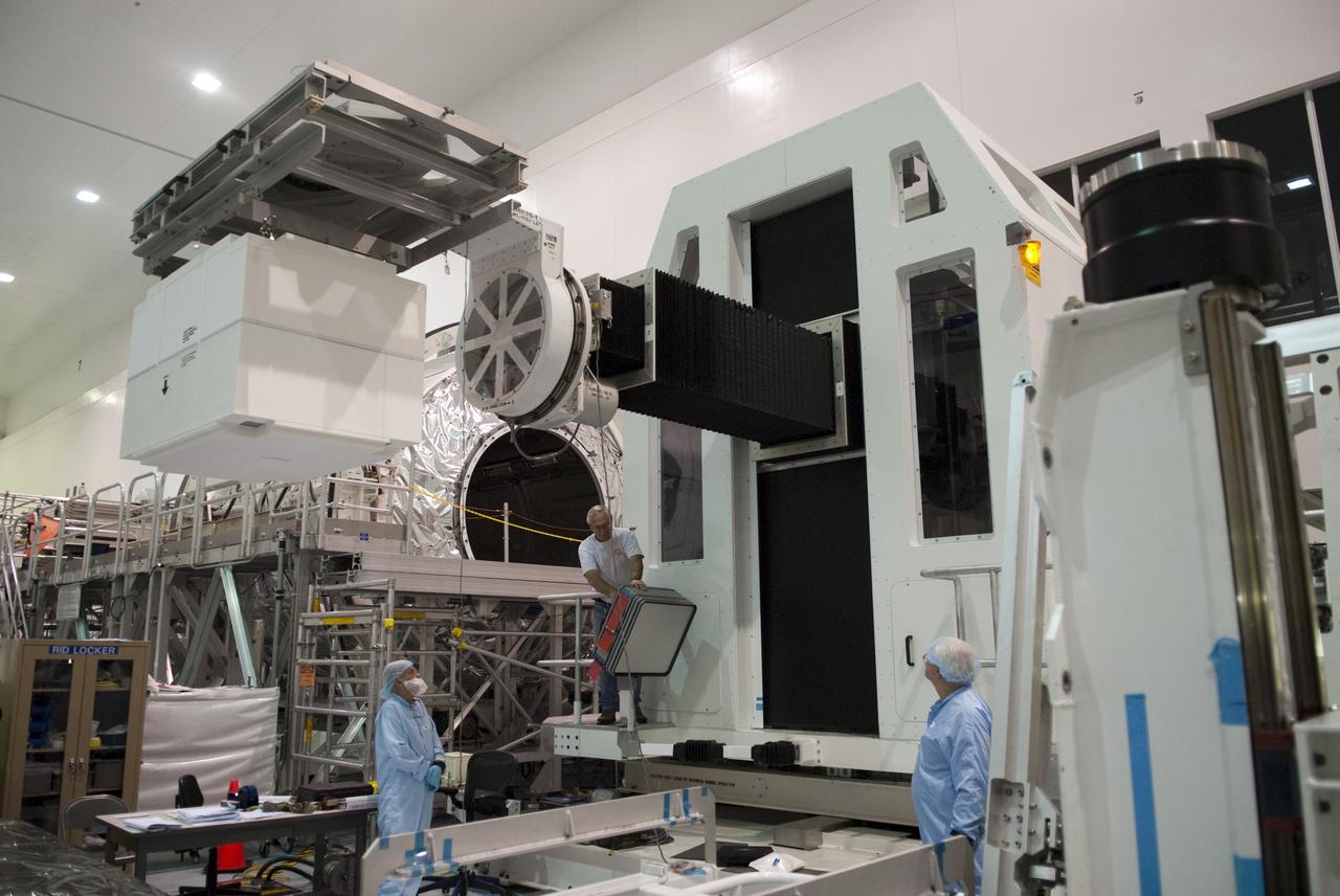 CAPE CANAVERAL, Fla. -- Technicians in the Space Station Processing Facility at NASA's Kennedy Space Center in Florida lift the dexterous humanoid astronaut helper, Robonaut 2, or R2, toward the Permanent Multipurpose Module, or PMM. Packed inside a launch box called SLEEPR, or Structural Launch Enclosure to Effectively Protect Robonaut, R2 will be placed in the in the same launch orientation as space shuttle Discovery's STS-133 crew members -- facing toward the nose of the shuttle with the back taking all the weight.              Although R2 will initially only participate in operational tests, upgrades could eventually allow the robot to realize its true purpose -- helping spacewalking astronauts with tasks outside the International Space Station. STS-133 is targeted to launch Nov. 1.  Photo credit: NASA/Frankie Martin