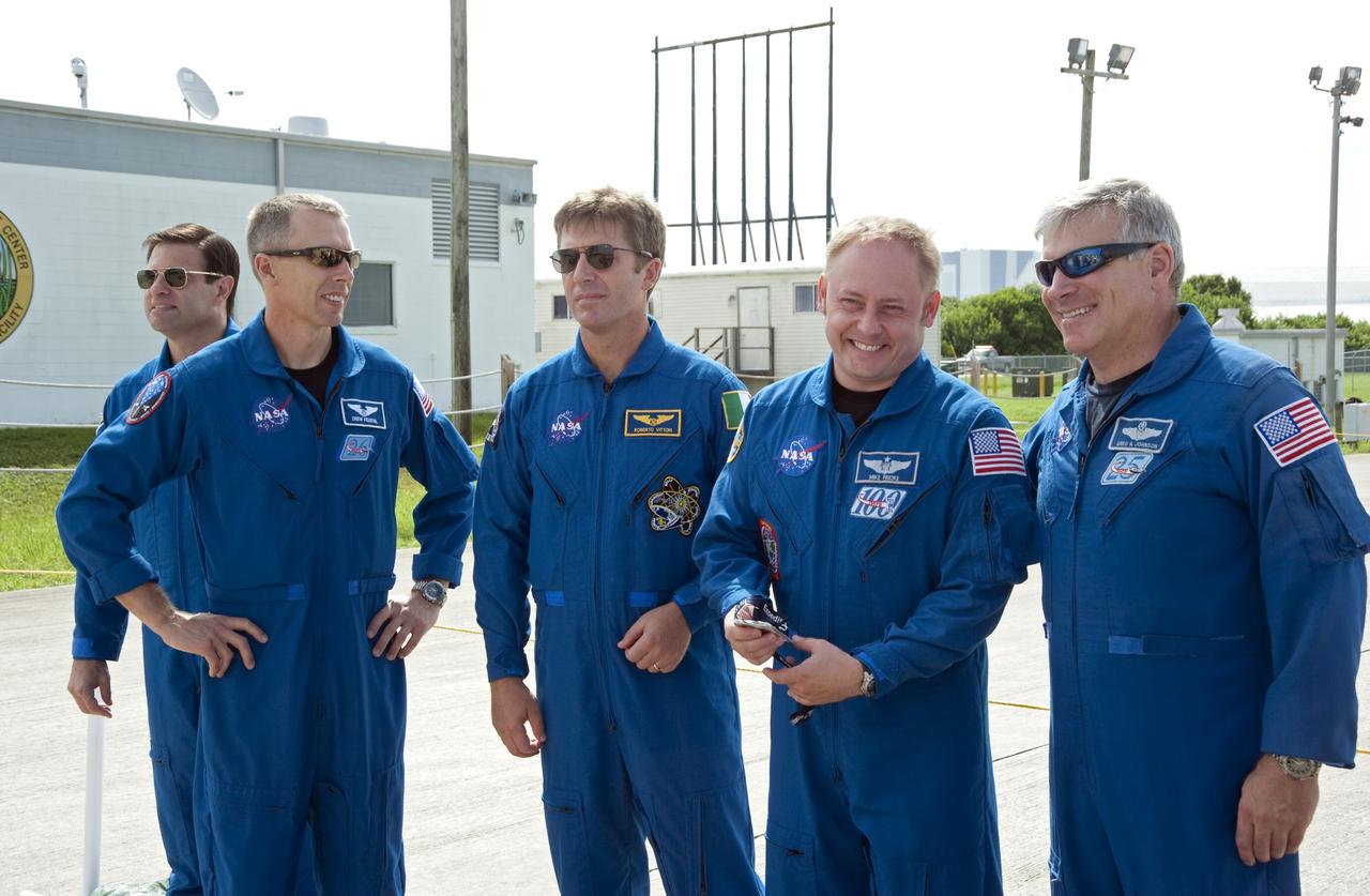 CAPE CANAVERAL, Fla. -- At the Shuttle Landing Facility at NASA's Kennedy Space Center in Florida, space shuttle Endeavour's STS-134 crew is on hand for the arrival of the Alpha Magnetic Spectrometer, or AMS. From left to right are Mission Specialists Greg Chamitoff, Andrew Feustel, European Space Agency astronaut Roberto Vittori, Mission Specialist Michael Fincke and Pilot Gregory H. Johnson.          AMS, a state-of-the-art particle physics detector, is designed to operate as an external module on the International Space Station. It will use the unique environment of space to study the universe and its origin by searching for dark matter. AMS will fly to the International Space Station aboard space shuttle Endeavour's STS-134 mission targeted to launch Feb. 26, 2011. Photo credit: NASA/Kim Shiflett