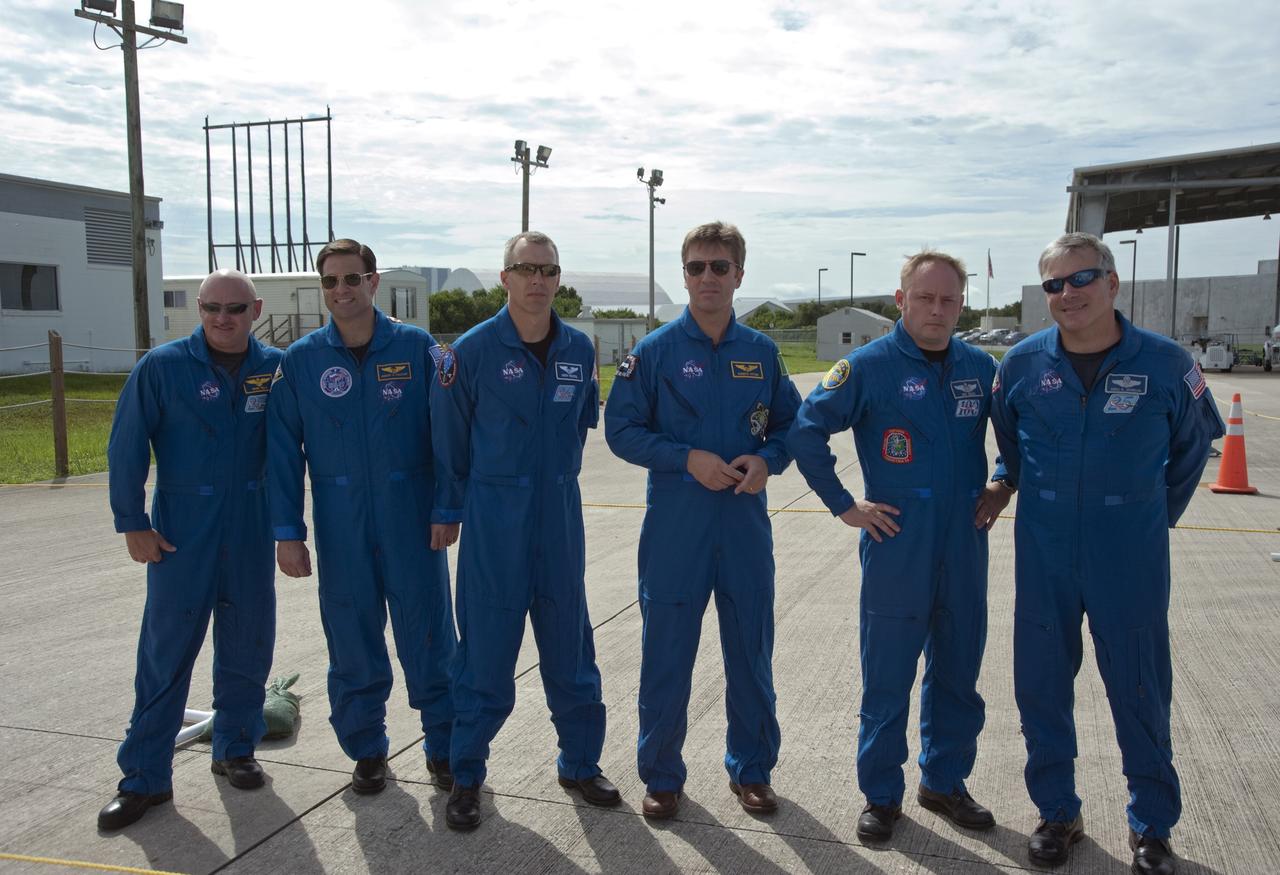 CAPE CANAVERAL, Fla. -- At the Shuttle Landing Facility at NASA's Kennedy Space Center in Florida, space shuttle Endeavour's STS-134 crew members pause for a photo prior to the arrival of the Alpha Magnetic Spectrometer, or AMS. From left to right are Commander Mark Kelly, Mission Specialists Greg Chamitoff, Andrew Feustel European Space Agency astronaut Roberto Vittori, Mission Specialist Michael Fincke and Pilot Gregory H. Johnson.          AMS, a state-of-the-art particle physics detector, is designed to operate as an external module on the International Space Station. It will use the unique environment of space to study the universe and its origin by searching for dark matter. AMS will fly to the International Space Station aboard space shuttle Endeavour's STS-134 mission targeted to launch Feb. 26, 2011. Photo credit: NASA/Kim Shiflett