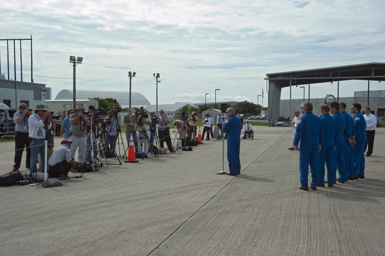 CAPE CANAVERAL, Fla. -- At the Shuttle Landing Facility at NASA's Kennedy Space Center in Florida, space shuttle Endeavour's STS-134 Commander Mark Kelly speaks to the media before the arrival of the Alpha Magnetic Spectrometer, or AMS.          AMS, a state-of-the-art particle physics detector, is designed to operate as an external module on the International Space Station. It will use the unique environment of space to study the universe and its origin by searching for dark matter. AMS will fly to the International Space Station aboard space shuttle Endeavour's STS-134 mission targeted to launch Feb. 26, 2011. Photo credit: NASA/Kim Shiflett