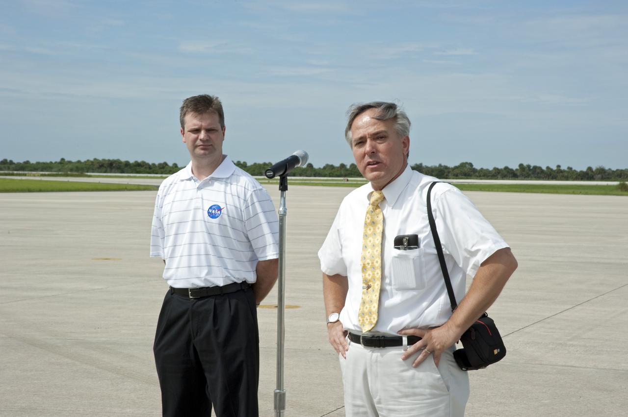 CAPE CANAVERAL, Fla. -- Mark Sistilli, AMS Program Manager from NASA Headquarters speaks to the media before the arrival of the Alpha Magnetic Spectrometer, or AMS, to the Shuttle Landing Facility at NASA's Kennedy Space Center in Florida, while Trent Martin, AMS Project Manager from NASA's Johnson Space Center in Houston looks on.                AMS, a state-of-the-art particle physics detector, is designed to operate as an external module on the International Space Station. It will use the unique environment of space to study the universe and its origin by searching for dark matter. The STS-134 crew will fly AMS to the International Space Station aboard space shuttle Endeavour,   targeted to launch Feb. 26, 2011. Photo credit: NASA/Kim Shiflett