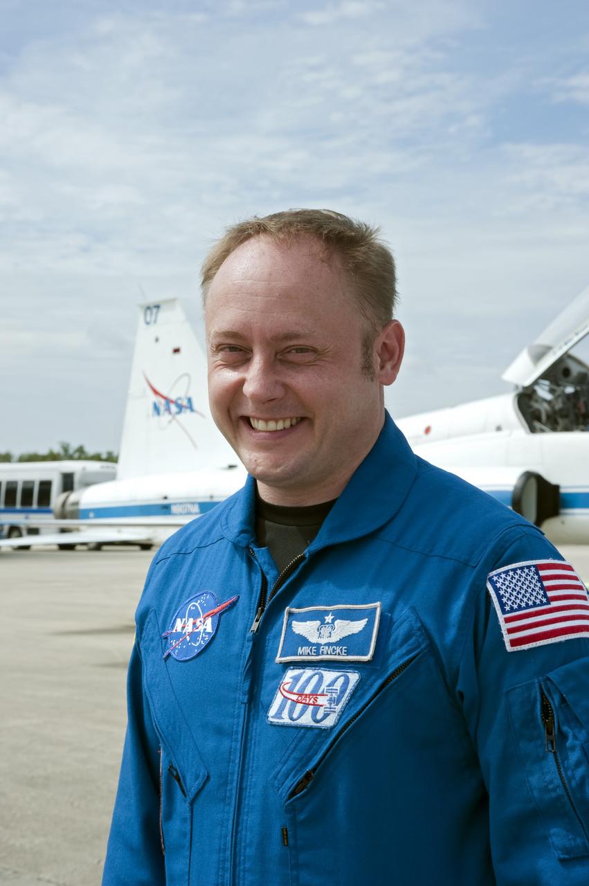 CAPE CANAVERAL, Fla. -- At the Shuttle Landing Facility at NASA's Kennedy Space Center in Florida, STS-134 Mission Specialist Michael Fincke pauses for a photo before the arrival of the Alpha Magnetic Spectrometer, or AMS.          AMS, a state-of-the-art particle physics detector, is designed to operate as an external module on the International Space Station. It will use the unique environment of space to study the universe and its origin by searching for dark matter. AMS will fly to the International Space Station aboard space shuttle Endeavour's STS-134 mission targeted to launch Feb. 26, 2011. Photo credit: NASA/Kim Shiflett