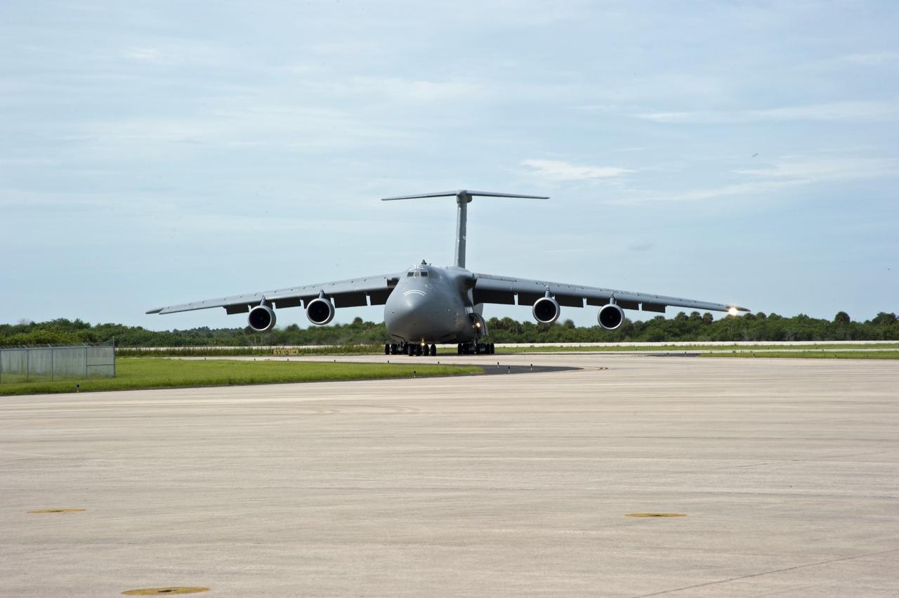 CAPE CANAVERAL, Fla. -- At NASA's Kennedy Space Center in Florida, the Alpha Magnetic Spectrometer, or AMS, arrives on the Shuttle Landing Facility runway aboard an Air Force C-5M aircraft from Europe. AMS is a state-of-the-art particle physics detector is designed to operate as an external module on the International Space Station. It will use the unique environment of space to study the universe and its origin by searching for dark matter. AMS will fly to the International Space Station aboard space shuttle Endeavour's STS-134 mission targeted to launch Feb. 26, 2011. Photo credit: NASA/Kim Shiflett