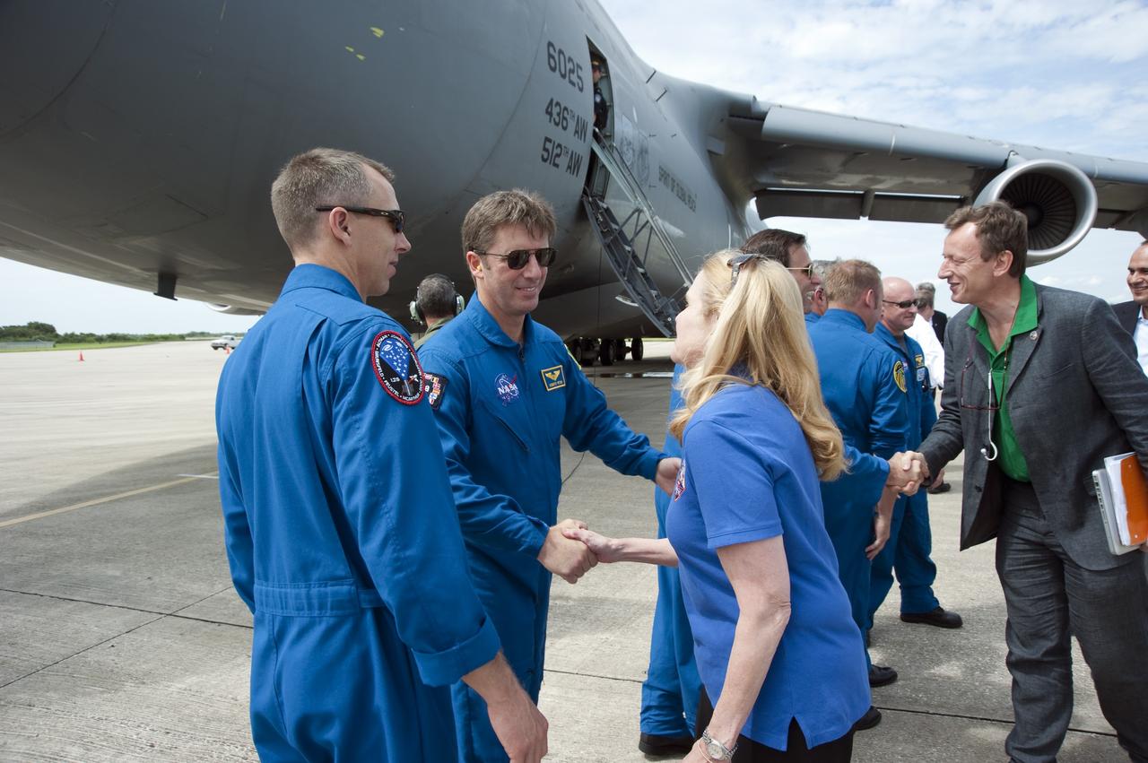 CAPE CANAVERAL, Fla. -- At the Shuttle Landing Facility at NASA's Kennedy Space Center in Florida, STS-134 Mission Specialist Andrew Feustel looks on as European Space Agency astronaut Roberto Vittori greets the media after the arrival of the Alpha Magnetic Spectrometer, or AMS.          AMS, a state-of-the-art particle physics detector, is designed to operate as an external module on the International Space Station. It will use the unique environment of space to study the universe and its origin by searching for dark matter. AMS will fly to the International Space Station aboard space shuttle Endeavour's STS-134 mission targeted to launch Feb. 26, 2011. Photo credit: NASA/Kim Shiflett