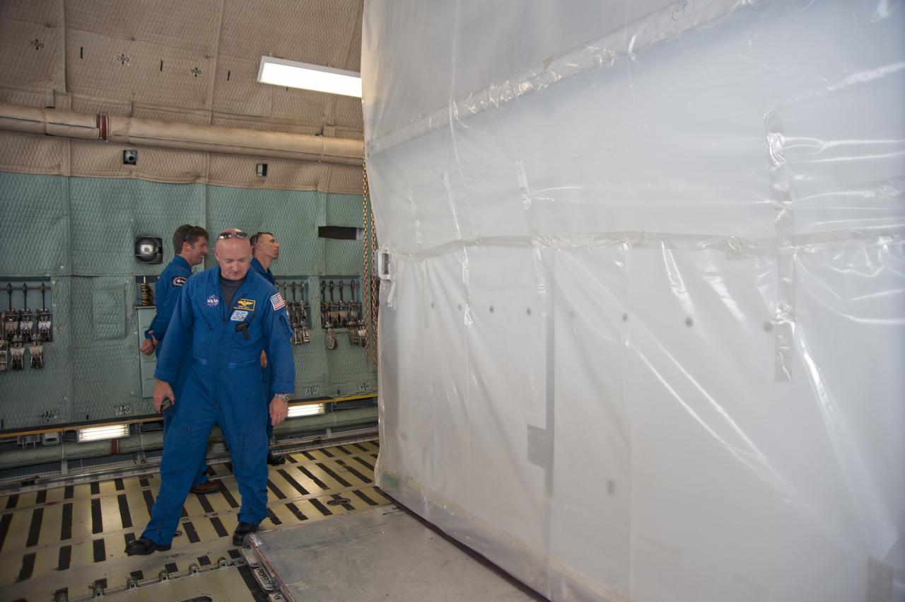CAPE CANAVERAL, Fla. -- At the Shuttle Landing Facility at NASA's Kennedy Space Center in Florida, STS-134 Commander Mark Kelly, European Space Agency astronaut Roberto Vittori (left) and Mission Specialist Andrew Feustel get a close look at the Alpha Magnetic Spectrometer, or AMS, inside the C-5M aircraft.          AMS, a state-of-the-art particle physics detector, is designed to operate as an external module on the International Space Station. It will use the unique environment of space to study the universe and its origin by searching for dark matter. AMS will fly to the International Space Station aboard space shuttle Endeavour's STS-134 mission targeted to launch Feb. 26, 2011. Photo credit: NASA/Kim Shiflett