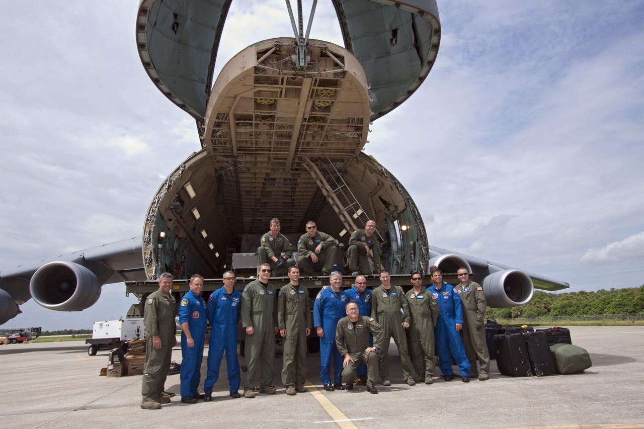 CAPE CANAVERAL, Fla. -- At NASA's Kennedy Space Center in Florida, STS-134 Mission Specialists Michael Fincke, Andrew Fuestel, Pilot Gregory C. Johnson, Commander Mark Kelly and Mission Specialist Greg Chamitoff (in blue flight suits) join the Air Force C-5M flight crew that delivered the Alpha Magnetic Spectrometer, or AMS, to the Shuttle Landing Facility, in a group photo opportunity.        AMS, a state-of-the-art particle physics detector, is designed to operate as an external module on the International Space Station. It will use the unique environment of space to study the universe and its origin by searching for dark matter. AMS will fly to the International Space Station aboard space shuttle Endeavour's STS-134 mission, targeted to launch Feb. 26, 2011. Photo credit: NASA/Jack Pfaller