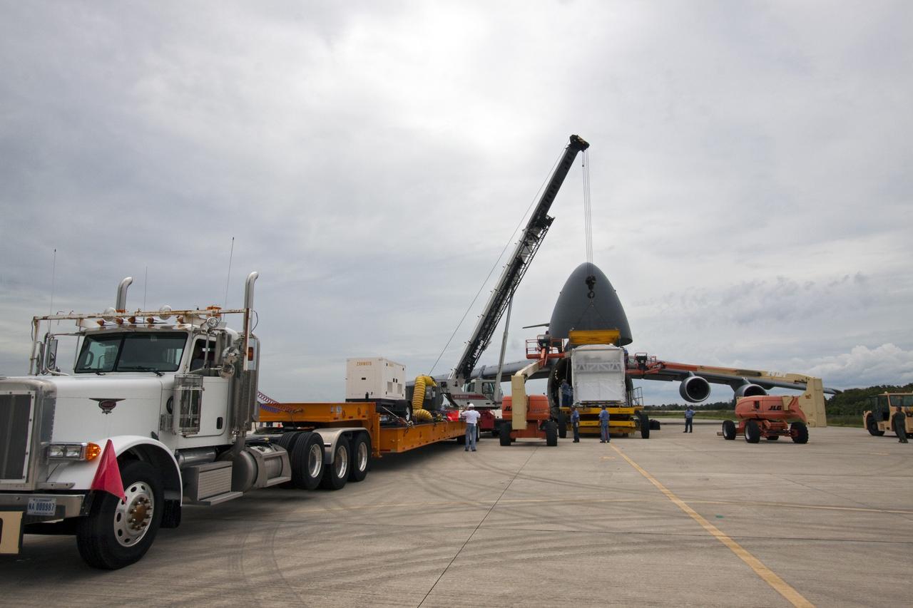 CAPE CANAVERAL, Fla. -- At NASA's Kennedy Space Center in Florida, a crane lifts the next section of the Alpha Magnetic Spectrometer, or AMS, toward a tractor-trailer which will transport the AMS from the Shuttle Landing Facility runway to the Space Station Processing Facility, where it will be processed for launch.        AMS, a state-of-the-art particle physics detector, is designed to operate as an external module on the International Space Station. It will use the unique environment of space to study the universe and its origin by searching for dark matter. AMS will fly to the International Space Station aboard space shuttle Endeavour's STS-134 mission, targeted to launch Feb. 26, 2011. Photo credit: NASA/Jack Pfaller