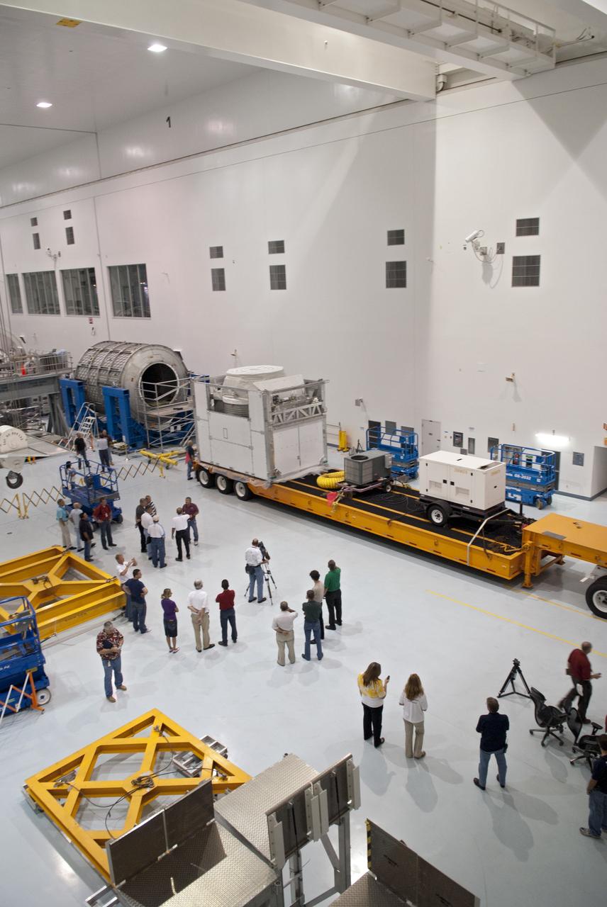 CAPE CANAVERAL, Fla. -- At NASA's Kennedy Space Center in Florida, media are on hand as the Alpha Magnetic Spectrometer, or AMS, is delivered to the Space Station Processing Facility, where it will be prepared for launch.          AMS, a state-of-the-art particle physics detector, is designed to operate as an external module on the International Space Station. It will use the unique environment of space to study the universe and its origin by searching for dark matter. The STS-134 crew will fly AMS to the International Space Station aboard space shuttle Endeavour,   targeted to launch Feb. 26, 2011. Photo credit: NASA/Frankie Martin
