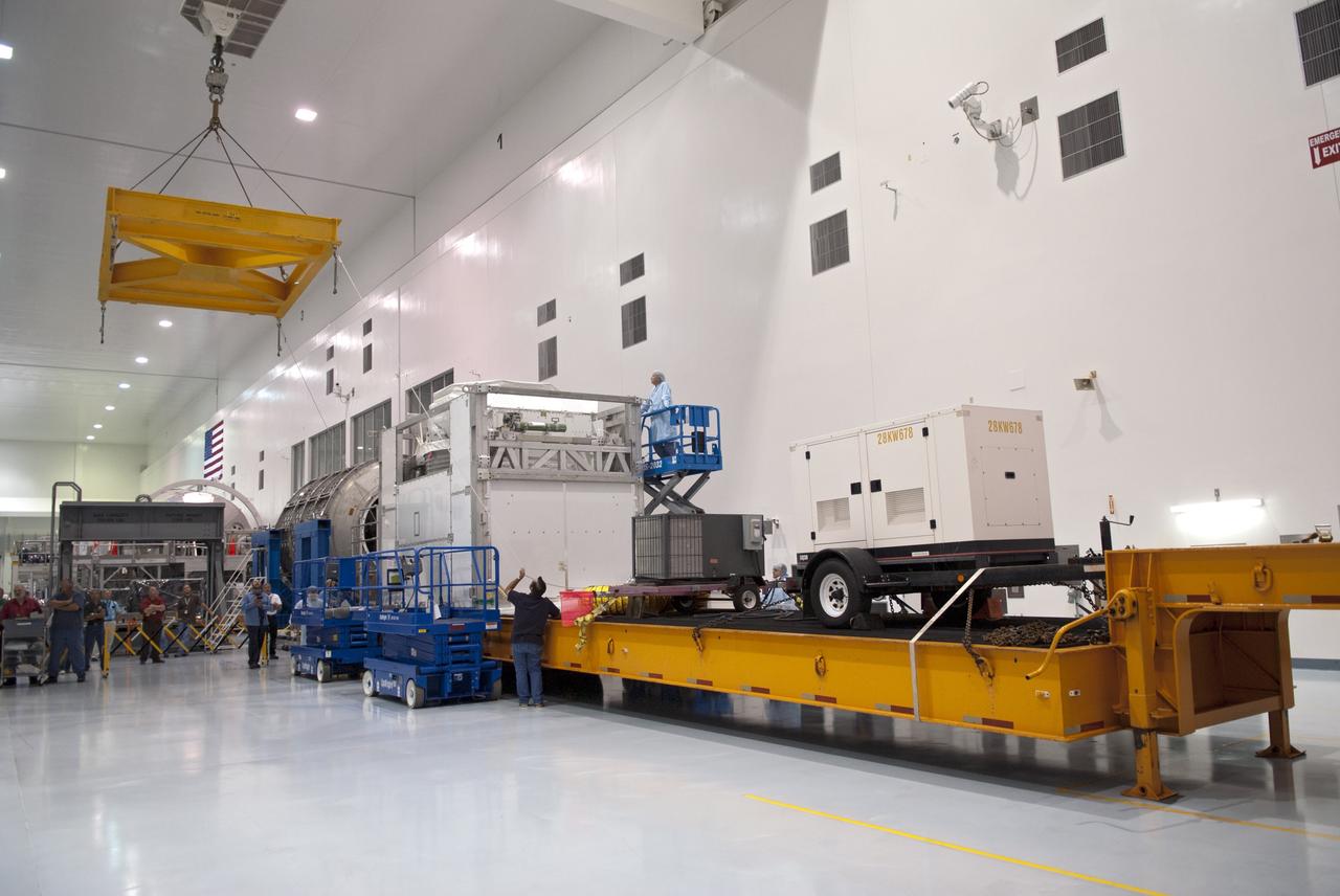 CAPE CANAVERAL, Fla. -- At NASA's Kennedy Space Center in Florida an overhead crane is poised above the floor of the Space Station Processing Facility to lift the Alpha Magnetic Spectrometer, or AMS, from the tractor-trailer that delivered it.          AMS, a state-of-the-art particle physics detector, is designed to operate as an external module on the International Space Station. It will use the unique environment of space to study the universe and its origin by searching for dark matter. The STS-134 crew will fly AMS to the International Space Station aboard space shuttle Endeavour,   targeted to launch Feb. 26, 2011. Photo credit: NASA/Frankie Martin