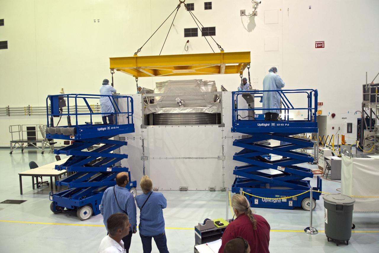 CAPE CANAVERAL, Fla. -- In the Space Station Processing Facility at NASA's Kennedy Space Center in Florida an overhead crane lowers the Alpha Magnetic Spectrometer, or AMS, onto to floor for technicians to prepare it for launch.        AMS, a state-of-the-art particle physics detector, is designed to operate as an external module on the International Space Station. It will use the unique environment of space to study the universe and its origin by searching for dark matter. The STS-134 crew will fly AMS to the International Space Station aboard space shuttle Endeavour,   targeted to launch Feb. 26, 2011. Photo credit: NASA/Frankie Martin