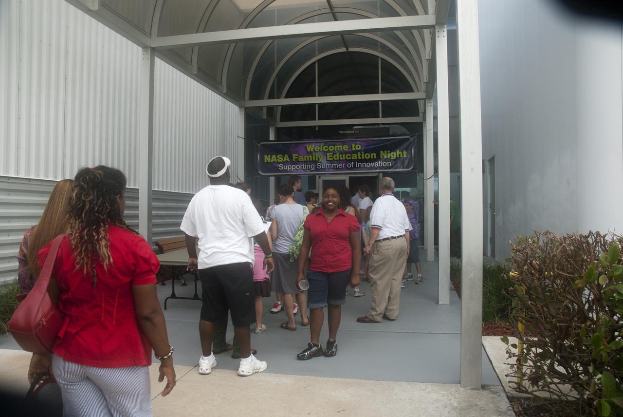 CAPE CANAVERAL, Fla. -- Fifth- through eighth-grade students and their parents enter the Astronaut Hall of Fame near the Kennedy Space Center Visitor Complex in Florida for the last NASA family education night event. Inside, they participated in science, technology, engineering and mathematics (STEM) activities, such as "gee-whiz" presentations, astronaut appearances, a hovercraft, vortex cannon and alternative fuel vehicles.      The event is part of NASA's Summer of Innovation initiative to provide interactive learning experiences to middle school students nationwide during the summer months. The program is a cornerstone of the Educate to Innovate campaign announced by President Barack Obama in November 2009. Photo credit: NASA/Charisse Nahser