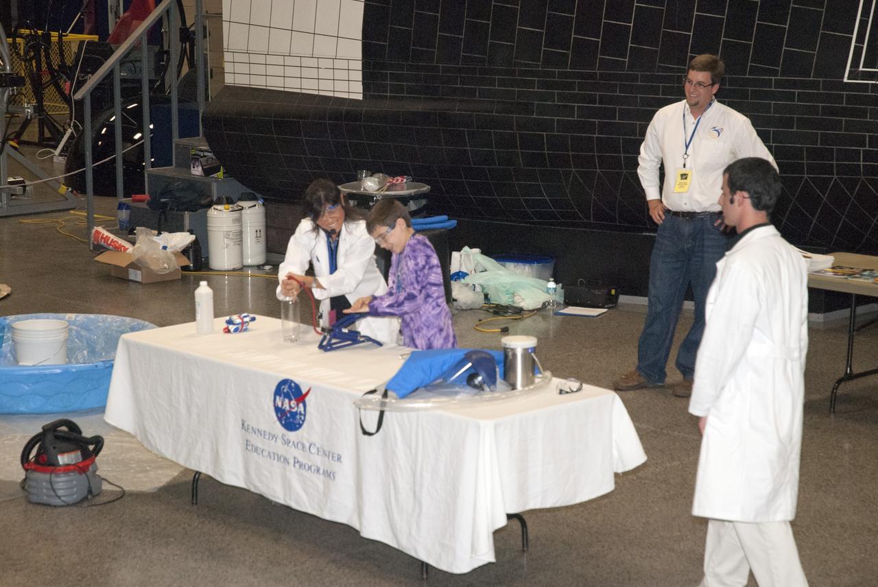 CAPE CANAVERAL, Fla. -- At the Astronaut Hall of Fame near the Kennedy Space Center Visitor Complex in Florida, a student participates in a "cloud-in-a-bottle" demonstration during the last NASA family education night event. Activities for fifth- through eighth-grade students and their parents included "gee-whiz" presentations, astronaut appearances, a hovercraft, vortex cannon and alternative fuel vehicles, which promote science, technology, engineering and mathematics (STEM) education.    The event is part of NASA's Summer of Innovation initiative to provide interactive learning experiences to middle school students nationwide during the summer months. The program is a cornerstone of the Educate to Innovate campaign announced by President Barack Obama in November 2009. Photo credit: NASA/Charisse Nahser