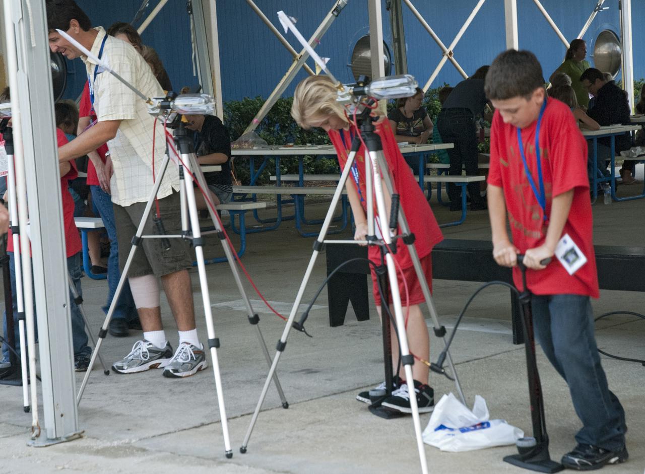 CAPE CANAVERAL, Fla. -- At the Astronaut Hall of Fame near the Kennedy Space Center Visitor Complex in Florida, fifth- through eighth-grade students and their parents participate in an air rocket experiment during the last NASA family education night event. Other activities included "gee-whiz" presentations, astronaut appearances, a hovercraft, vortex cannon and alternative fuel vehicles, which promote science, technology, engineering and mathematics (STEM) education.    The event is part of NASA's Summer of Innovation initiative to provide interactive learning experiences to middle school students nationwide during the summer months. The program is a cornerstone of the Educate to Innovate campaign announced by President Barack Obama in November 2009. Photo credit: NASA/Charisse Nahser