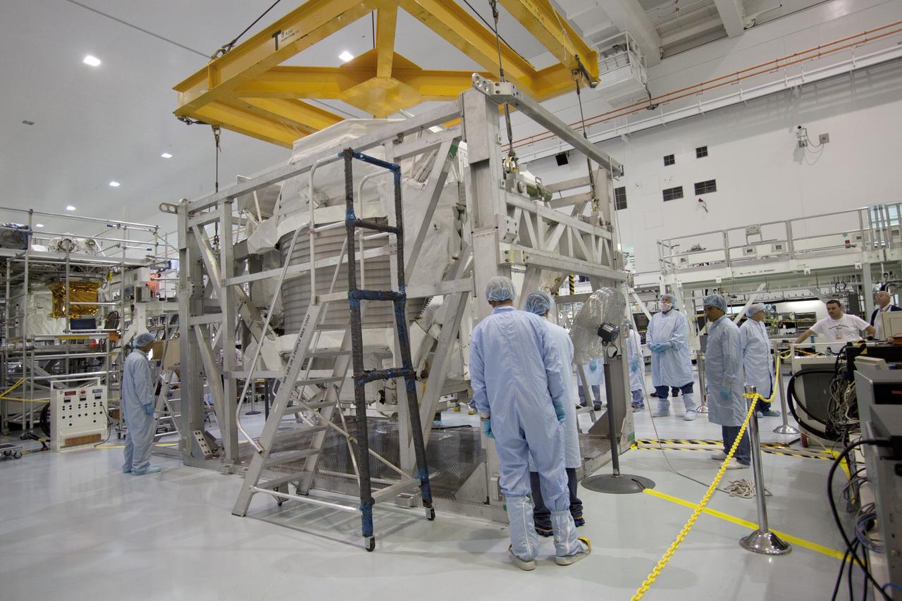 CAPE CANAVERAL, Fla. -- In the Space Station Processing Facility at NASA's Kennedy Space Center in Florida, an overhead crane lifts the Alpha Magnetic Spectrometer, or AMS, so it can be lifted onto a work stand and processed for launch.       AMS, a state-of-the-art particle physics detector, is designed to operate as an external module on the International Space Station. It will use the unique environment of space to study the universe and its origin by searching for dark matter. AMS will fly to the International Space Station aboard space shuttle Endeavour's STS-134 mission targeted to launch Feb. 26, 2011. Photo credit: NASA/Jack Pfaller