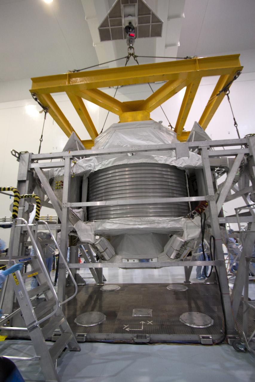 CAPE CANAVERAL, Fla. -- In the Space Station Processing Facility at NASA's Kennedy Space Center in Florida, an overhead crane lifts the Alpha Magnetic Spectrometer, or AMS, so it can be placed onto a work stand and processed for launch.       AMS, a state-of-the-art particle physics detector, is designed to operate as an external module on the International Space Station. It will use the unique environment of space to study the universe and its origin by searching for dark matter. AMS will fly to the International Space Station aboard space shuttle Endeavour's STS-134 mission targeted to launch Feb. 26, 2011. Photo credit: NASA/Jack Pfaller