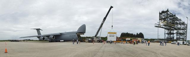 CAPE CANAVERAL, Fla. -- At NASA's Kennedy Space Center in Florida, workers offload the Alpha Magnetic Spectrometer (AMS) from an Air Force C-5M aircraft on the Shuttle Landing Facility runway. The state-of-the-art particle physics detector arrived at Kennedy from Europe and will operate as an external module on the International Space Station to study the universe and its origin by searching for dark matter. AMS will fly to the station aboard space shuttle Endeavour's STS-134 mission targeted to launch Feb. 26, 2011. Photo credit: NASA/Frankie Martin