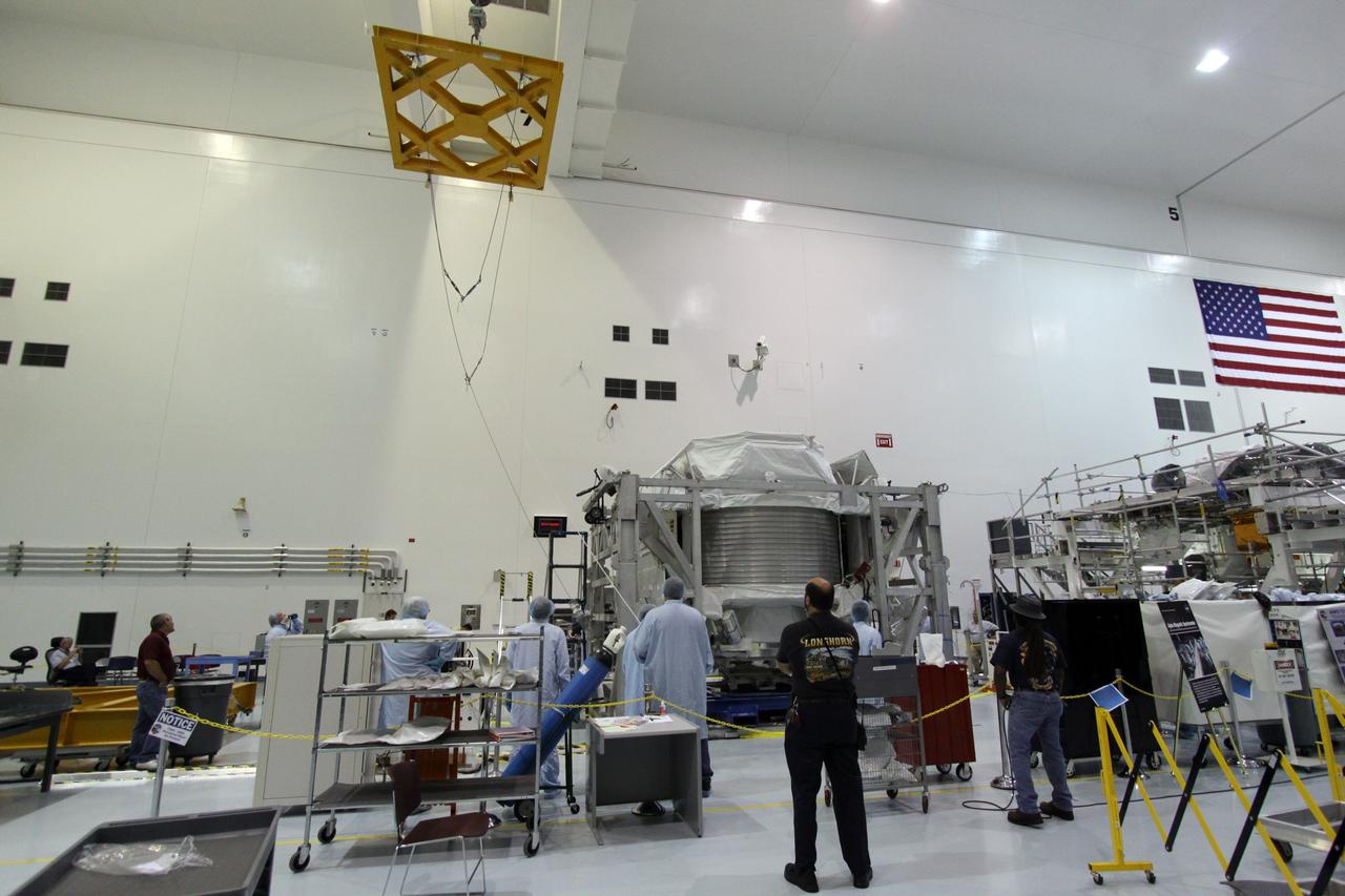 CAPE CANAVERAL, Fla. -- In the Space Station Processing Facility at NASA's Kennedy Space Center in Florida, an overhead crane is poised over the Alpha Magnetic Spectrometer, or AMS, to lift the Payload Attach System, or PAS, up to the AMS. The PAS provides a method of securely connecting the payload to the International Space Station. AMS, a state-of-the-art particle physics detector, is designed to operate as an external module on the International Space Station. It will use the unique environment of space to study the universe and its origin by searching for dark matter. AMS will fly to the station aboard space shuttle Endeavour's STS-134 mission targeted to launch Feb. 26, 2011. Photo credit: NASA/Jack Pfaller