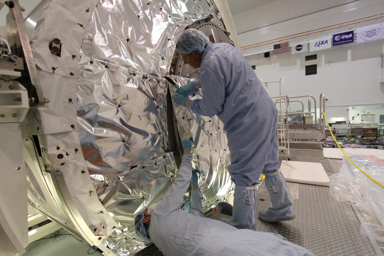 CAPE CANAVERAL, Fla. -- In the Space Station Processing Facility at NASA's Kennedy Space Center in Florida, technicians cover the hatch of the Permanent Multipurpose Module, or PMM, with insulating blankets to protect it and its contents from the harsh environment and temperatures of space. Space shuttle Discovery and its STS-133 crew are targeted to launch Nov. 1 and will deliver the PMM, packed with supplies and critical spare parts, as well as Robonaut 2, the dexterous humanoid astronaut helper, to the International Space Station. For more information visit: www.nasa.gov/shuttle. Photo credit: NASA/Jack Pfaller
