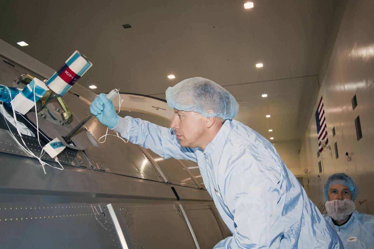 CAPE CANAVERAL, Fla. --  In the Space Station Processing Facility at NASA's Kennedy Space Center in Florida, STS-133 Mission Specialist Tim Kopra practices using a tool on the Permanent Multipurpose Module, or PMM.         The astronauts are at Kennedy to participate in the Payload Crew Equipment Interface Test, or CEIT, which gives  the crew an opportunity for hands-on training with tools they'll be using in space and familiarization of the payload they will be delivering to the International Space Station. Launch of space shuttle Discovery is targeted for Nov. 1 at 4:40 p.m. EDT. For more information visit, www.nasa.gov/shuttle. Photo credit: NASA/Jack Pfaller