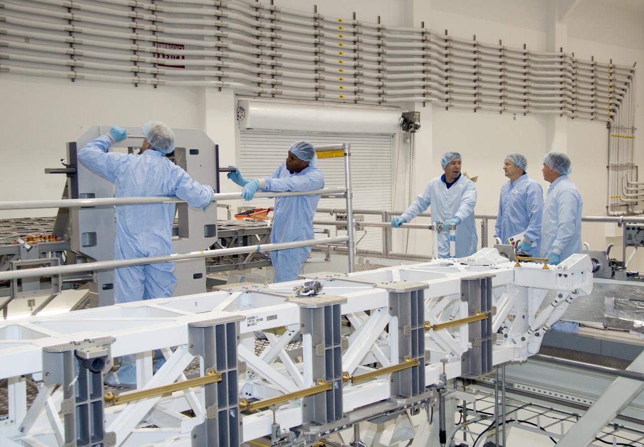 CAPE CANAVERAL, Fla. -- In the Space Station Processing Facility at NASA's Kennedy Space Center in Florida, STS-133 Mission Specialists Tim Kopra (left) and Alvin Drew inspect a component of the payload as Mission Specialist Michael Barratt and Pilot Eric Boe look on. The astronauts are at Kennedy to participate in the Payload Crew Equipment Interface Test, or CEIT, which gives the crew an opportunity for hands-on training with tools they'll be using in space and familiarization of the payload they will be delivering to the International Space Station. Launch of space shuttle Discovery is targeted for Nov. 1 at 4:40 p.m. EDT. For more information visit, www.nasa.gov/shuttle. Photo credit: NASA/Jack Pfaller
