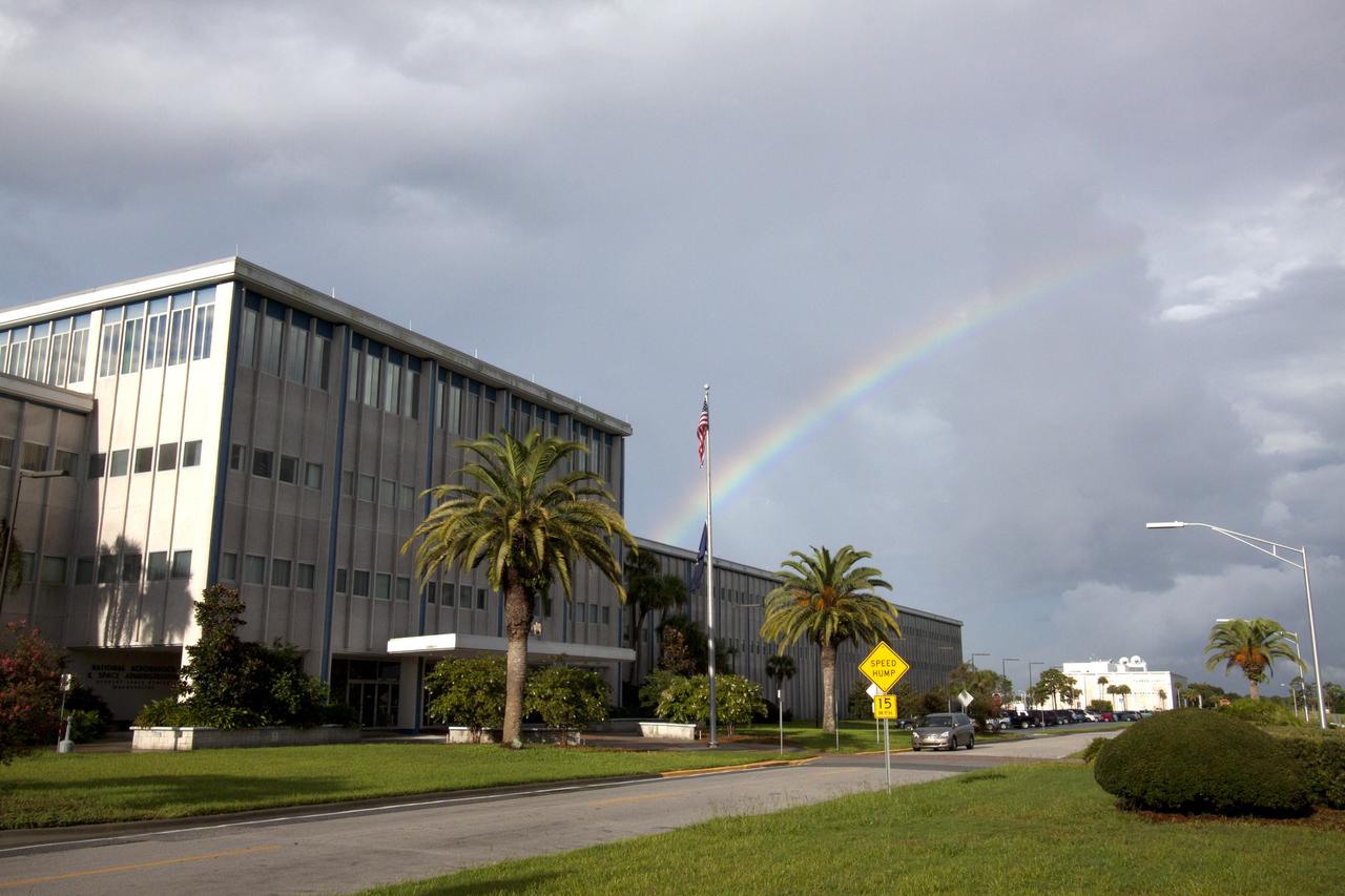 CAPE CANAVERAL, Fla. -- As the sun was rising over NASA's Kennedy Space Center in Florida, an early morning rain shower caused a meteorological and optical rainbow show over the Headquarters building.    Florida's Space Coast often is the scene of showers and thunderstorms during the summer months.  Photo credit: NASA/Jack Pfaller
