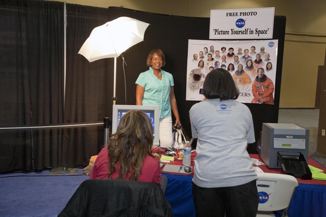 ORLANDO, Fla. -- Attendees of the 2010 Tom Joyner Family Reunion were photographed and then their faces were put into a NASA "Legends and Trailblazers" poster at the Gaylord Palms Convention Center in Orlando, Fla. To encourage student attendees to focus on pursuing careers in science, technology, engineering and mathematics (STEM), NASA featured some of its greatest legends and trailblazers during a panel discussion at the reunion event. NASA's Education Office sponsored the panel discussion and educational activities as part of the agency's "Summer of Innovation" initiative and the federal "Educate to Innovate" campaign. Photo credit: NASA/Amanda Diller