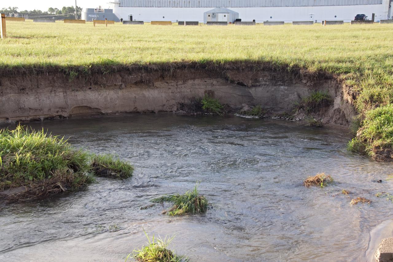 CAPE CANAVERAL, Fla. -- In the LC-39 Complex Turn Basin area across from the Vehicle Assembly Building at NASA's Kennedy Space Center in Florida, a major water main leak in a 24-inch pipe caused soil to wash away near the Press Site. The center was closed for the morning while workers assessed and repaired the break. In the background is the Pegasus barge docked at the Turn Basin which is used to deliver the space shuttle external fuel tank. Photo credit: NASA/Jack Pfaller