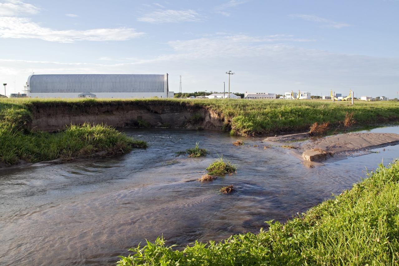 CAPE CANAVERAL, Fla. -- In the LC-39 Complex Turn Basin area across from the Vehicle Assembly Building at NASA's Kennedy Space Center in Florida, a major water main leak in a 24-inch pipe caused soil to wash away near the Press Site. The center was closed for the morning while workers assessed and repaired the break. In the background is the Pegasus barge docked at the Turn Basin which is used to deliver the space shuttle external fuel tank. Photo credit: NASA/Jack Pfaller