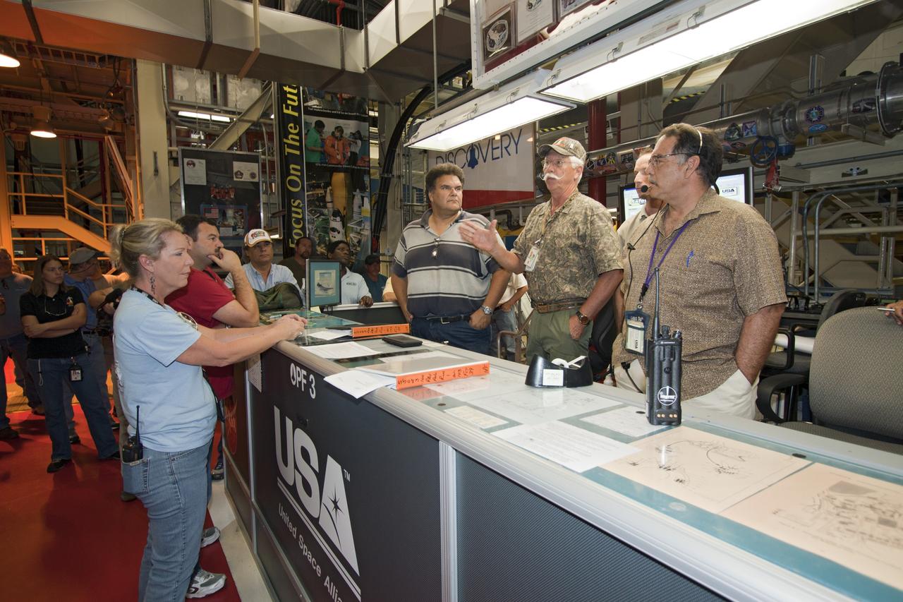 CAPE CANAVERAL, Fla. -- In Orbiter Processing Facility-3 at NASA's Kennedy Space Center in Florida, workers discuss moving, or "rolling over," shuttle Discovery to the nearby Vehicle Assembly Building (VAB). Once inside the VAB, the shuttle will be joined to its solid rocket boosters and external fuel tank. Later this month, Discovery is scheduled to "rollout" to Launch Pad 39A for its launch to the International Space Station on the STS-133 mission. Targeted to liftoff Nov. 1, Discovery will take the Permanent Multipurpose Module (PMM) packed with supplies and critical spare parts, as well as Robonaut 2 (R2) to the station. Photo credit: NASA/Jack Pfaller