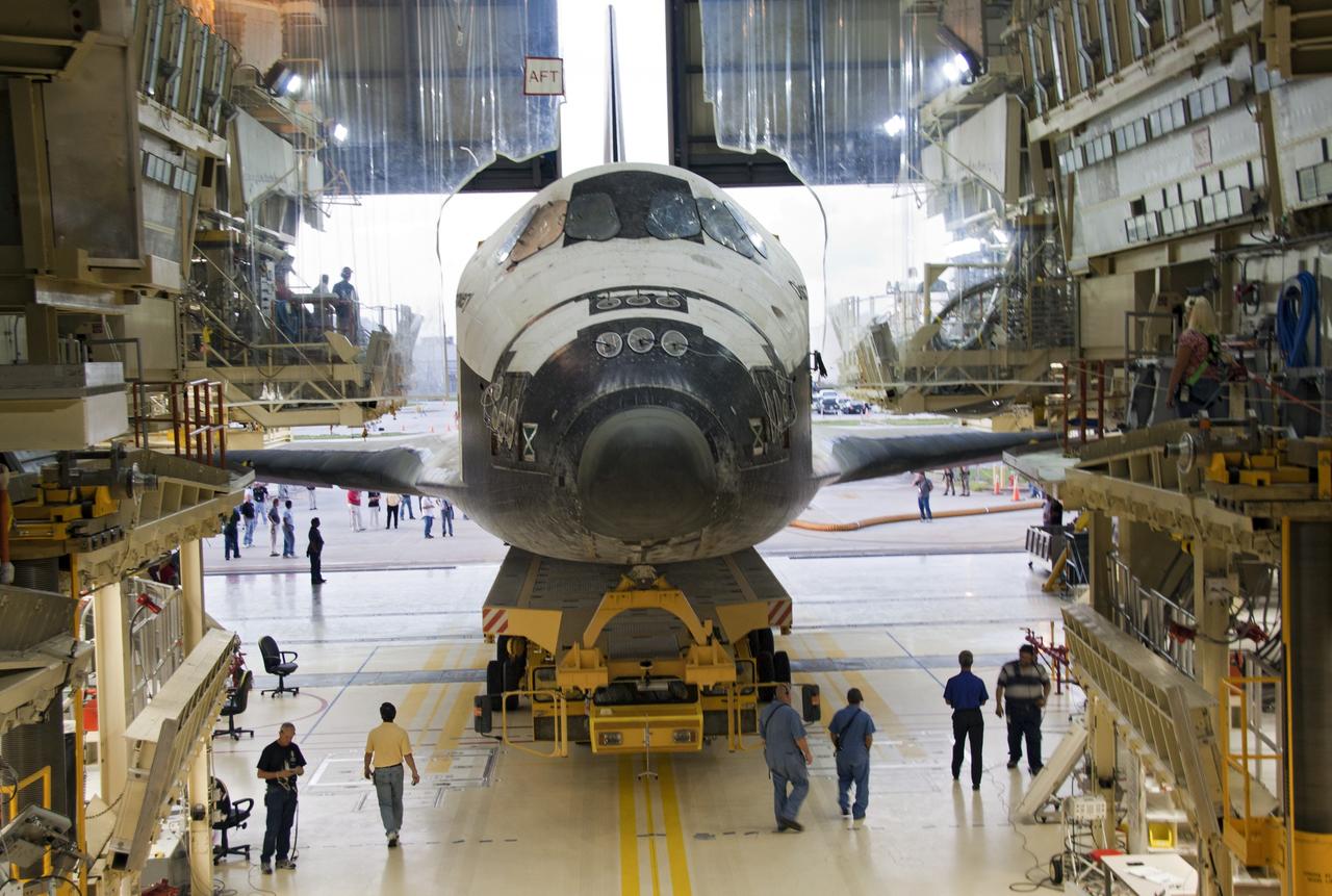 CAPE CANAVERAL, Fla. -- At NASA's Kennedy Space Center in Florida, shuttle Discovery begins to back out of Orbiter Processing Facility-3 during a move called "rollover" to the nearby Vehicle Assembly Building (VAB). Once inside the VAB, the shuttle will be joined to its solid rocket boosters and external fuel tank. Later this month, Discovery is scheduled to "rollout" to Launch Pad 39A for its launch to the International Space Station on the STS-133 mission. Targeted to liftoff Nov. 1, Discovery will take the Permanent Multipurpose Module (PMM) packed with supplies and critical spare parts, as well as Robonaut 2 (R2) to the station. Photo credit: NASA/Jack Pfaller